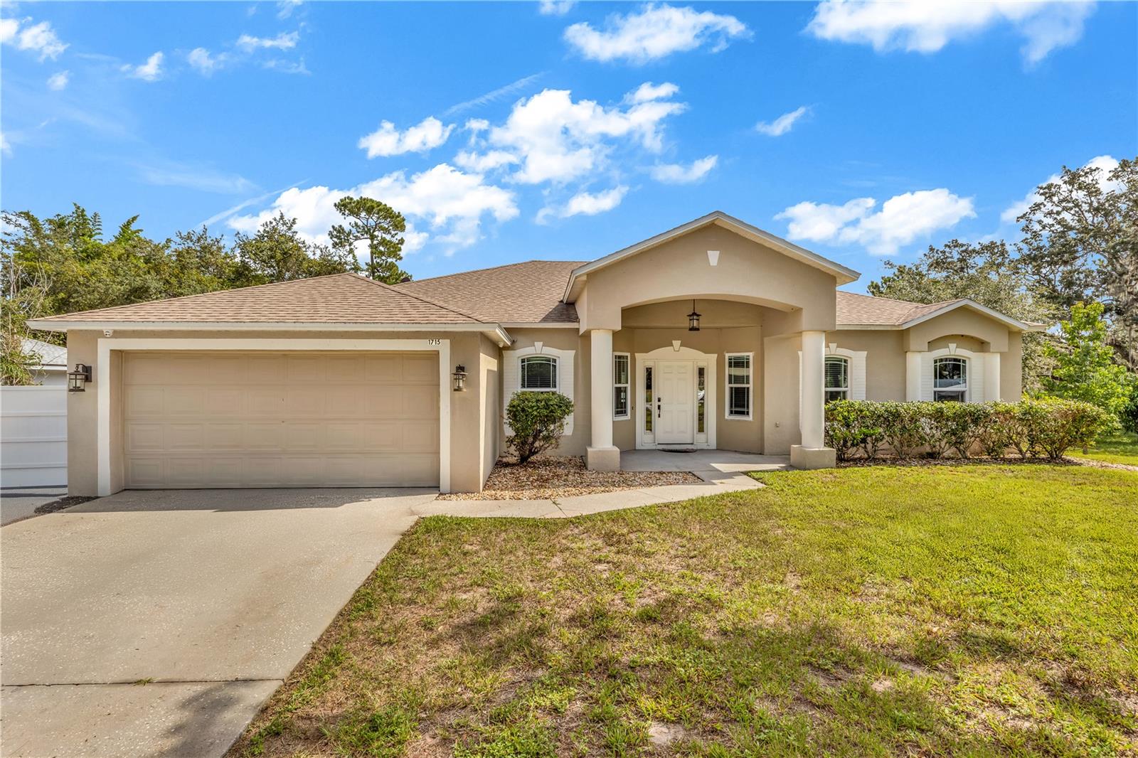 Welcome to your dream home in beautiful Deltona Lakes! From the moment you arrive, you’ll be greeted by the cheerful, generous front porch—just waiting for your morning coffee, friendly chats, or quiet moments to soak in the sunshine. Step inside and feel the bright, open-concept layout instantly lift your spirits as it connects the airy living, dining, and kitchen areas—perfect for creating joyful memories every day and hosting unforgettable gatherings. This wonderful split floor plan features four generously sized bedrooms and a dedicated office right off the front foyer—ideal for working from home or crafting your favorite hobbies. One of the full bathrooms functions as a convenient pool bath en-suite, with direct access to the spacious enclosed and covered back porch and outdoor living area. Speaking of the kitchen, it’s a chef’s delight! Equipped with granite countertops, a brand new oven with a built-in air fryer, stainless steel refrigerator, and plenty of counter space, it invites you to cook up your favorite meals and share laughter around the table. Beautiful luxury vinyl plank flooring installed in 2021 flows throughout the home, making every step feel smooth and stylish. Step outside to your personal paradise! Enjoy your mornings and evenings on the expansive enclosed and covered back porch or the roomy deck while soaking in stunning lake views and breathtaking sunrises and sunsets. Dive into the above-ground pool to refresh on warm days, and take advantage of the generous lot with a handy storage shed for all your extras. The best part is this home is move-in ready—no expensive or difficult projects here! Roof replaced in 2019, Energy Star windows and French doors installed in 2021, plus an oversized water heater. You can simply relax and enjoy your beautiful new home right away. Nestled in a peaceful, friendly neighborhood, this home perfectly blends modern updates, smart design, and nature’s beauty. Don’t miss your chance to start the next exciting chapter of your life in this lakeside treasure!