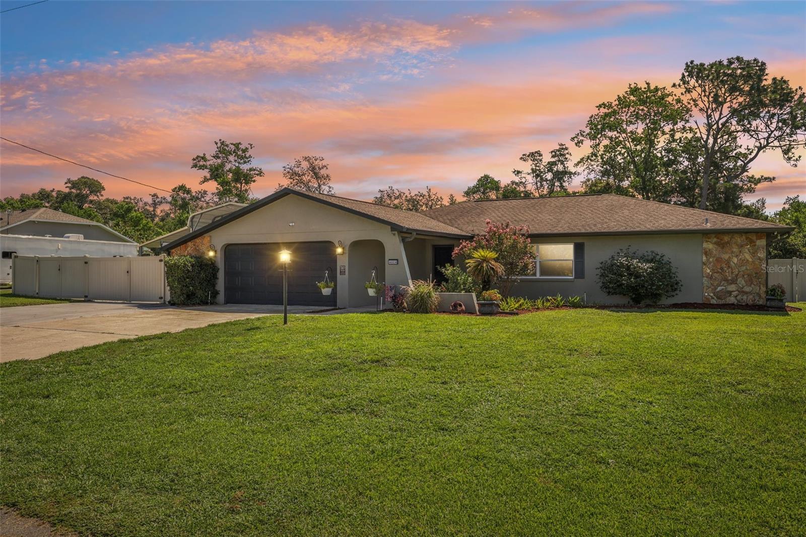 This beautifully built 3-bedroom, 2-bathroom, 2-car garage, Pool Home is in the highly desirable neighborhood of Springwood Estates. Enter through the front door and you will immediately feel at home. This home offers a split bedroom floor plan with a centralized kitchen, living room, family room and dining room. The separate living room has a built-in entertainment center with electric fireplace, and access to the lanai. The Large Master Suite has a private entrance to the pool, large walk-in closet, and master bath has a walk in, tiled shower. The all-new kitchen has been completely remodeled with deep cabinets, lazy Susan, granite countertops, new sink and all matching appliances. Artisan built upper shelves, back splash, and separate coffee bar are an amazing touch. All new PVC wood grain vinyl flooring installed throughout with new baseboards – there is no carpet in this home. Upgraded Hurricane rated double paned windows throughout. The light fixtures, ceiling fans, outlets and switches have been replaced. The inside laundry room has a built-in pet area, washer / dryer hook ups, upper cabinets and a stainless utility sink. The two-car garage gives a lot of flexibility for parking and bump out workshop area with a built-in work bench is a bonus. New garage door opener is WIFI capable with built-in security camera. The covered lanai was rescreened and is the perfect place to sit back, relax and enjoy. The pool is amazing! It’s a 6-foot-deep heated pool, measuring 15x30, and it has a new(er) saltwater system that keeps the water clear - no need to add chlorine. The landscaped back yard has been surrounded with vinyl privacy fencing. The custom RV car port with Lein-to has 50-amp electrical service and the driveway was extended by an additional 25x40 feet. New rain gutters, zoned irrigation system with new valves and control box, utility shed, gray water drain field replaced 2025. Hardwired for security (cameras do not convey) The roof was replaced (11/2012) and the 3rd nail was recently installed (for wind mitigation purposes), A/C unit had been serviced regularly, and the duct work has been professionally cleaned. Septic pumped every 3 years, and pest control provided quarterly. Attention to detail, and pride in ownership is evident, as this home exceptionally clean, meticulously maintained and 100% move in ready. Springwood is a deed restricted community and there is a HOA – however this home is grandfathered in - the owners do not have to join or pay any HOA fees. Flood Zone X means there is no flood insurance requirement. Call today for your private tour, and if you have any questions just ask.
