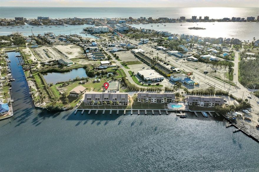 Welcome to your waterfront retreat in Fort Myers Beach! This beautifully appointed two-bedroom, three-bathroom, two-story condo sits high and dry on the second floor—offering the peace of mind you deserve along with breathtaking, serene views of the bay. Ideally situated just minutes from the sun-soaked shores of Fort Myers Beach and the unspoiled natural beauty of Lovers Key State Park, this property places you at the heart of Southwest Florida's most coveted coastal lifestyle. Whether you're looking for a full-time residence, a seasonal retreat, or an investment opportunity, this turnkey gem checks every box—sold fully furnished and move-in ready from day one. For boating enthusiasts, this is nothing short of a dream. Enjoy quick, direct access to the Gulf right from your backyard, complete with a deeded dock, a community boat ramp, and an on-site boatyard—eliminating the need and expense of off-site marina storage. Cast your line from the on-site fishing pier, then head straight to the fish cut and wash station to prep your fresh catch with ease. When it's time to relax, take a dip in the sparkling community pool, perfect your serve on the tennis court, or simply soak up the legendary Florida sunshine. Every day here feels like a vacation. This is more than a condo—it's a lifestyle. Don't miss your opportunity to own a piece of Fort Myers Beach paradise.