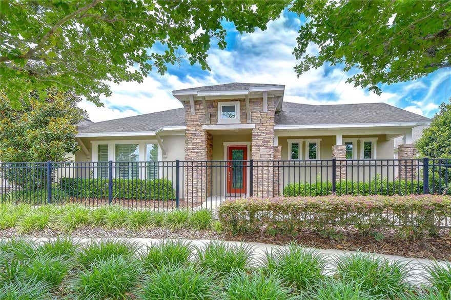 This one-of-a-kind David Weekley former model home showcases the highly sought-after Southwind floor plan and is perfectly positioned within the gated 55+ Encore community of FishHawk West. Designed to impress and meticulously maintained, the home still shows like a model, offering a refined single-story living experience where timeless elegance meets everyday comfort. Thoughtful updates by the current owner include a fully redesigned kitchen, fresh interior paint, a beautifully remodeled laundry room, custom Norman shutters, and an upgraded pantry, ensuring the home feels both current and completely move-in ready. From the moment you arrive, the striking exterior sets the tone with stone accents, designer siding, and architectural detailing that reflects true model-home craftsmanship, along with convenient guest parking just steps away. Inside, you’re welcomed by a bright, airy floor plan filled with natural light, highlighted by 10-foot ceilings, crown molding, plantation shutters, and rich wood-look flooring flowing throughout the main living areas and owner’s retreat. The kitchen is truly the heart of the home and a standout showpiece, thoughtfully reimagined with stacked cabinetry extending to the ceiling, Cambria quartz countertops, an oversized island, and custom in-cabinet and under-cabinet lighting that adds both warmth and functionality. Designed for both everyday living and elevated entertaining, the kitchen features a built-in oven and microwave, along with a separate high-end Electrolux range and oven, offering the flexibility of multiple cooking options—perfect for hosting holidays and gatherings. Deep, soft-close drawers with pull-out storage complete the space, blending beauty with exceptional organization and ease of use. Seamlessly connected to the kitchen, the dining area was intentionally designed as a place to gather, celebrate, and make memories, with ample space to host the entire family for holidays, special occasions, and unforgettable dinners. The open flow into the family room creates an inviting atmosphere ideal for entertaining while still feeling warm and comfortable for everyday living. With two bedrooms plus a den and 2.5 baths, the layout offers flexibility for guests, a home office, or additional living space, all finished with the same attention to detail found in a designer showcase. As a resident of Encore, you’ll enjoy exclusive access to The Oasis Club, along with the full suite of FishHawk West amenities, including the Lake House, scenic walking trails, dog park, resort-style pools, fitness facilities, beautifully maintained parks, and as a bonus, the HOA includes internet and cable—delivering a lifestyle as exceptional as the home itself.