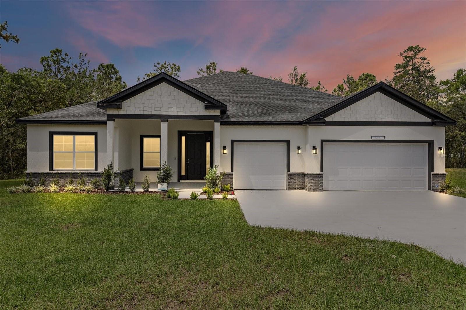 Ask about our Builder Incentives! High end luxury meets affordability in this stunning 4-bedroom 3-bathroom 3 car garage home situated on a central lot close to all things Ocala! Stand out features include Calacatta White Quartz countertops, designer tile selections in all the bathrooms, Samsung stainless steel appliances plus washer and dryer, 9'4'' ceiling & 8' doors throughout the entire home, Mohawk Ballard LVP flooring throughout (NO CARPET), and so much more. From the moment you arrive you will notice the oversized driveway with ample parking and tasteful brick accents. Once inside, you will love the open floor plan with the living room, dining room and kitchen all flowing together in perfect harmony. The kitchen features 42'' upper cabinets, walk-in pantry, and an oversized island that is sure be the statement piece of this home. The Master suite is expansive with tray ceiling, dual sink vanity with beauty station, huge walk-in closet, and gorgeous shower. Guest bedrooms are all very well sized with 2 bedrooms sharing a jack and jill bathroom with dual sinks. Indoor utility room with tons of natural light will make laundry your favorite chore. The secluded covered lanai is perfect for grilling or just relaxing with family and friends. This home won't last long, so schedule your private tour today before it's too late! *Photos from previous built model most colors/finishes are the same please inquire for exact selections*
