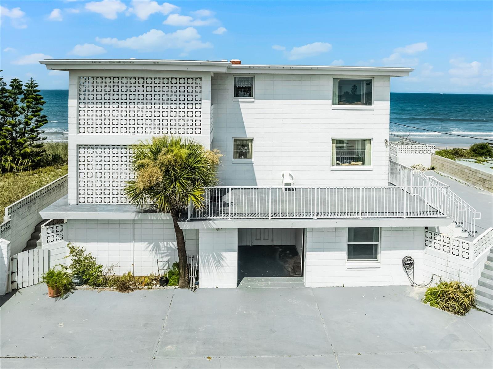 Once-in-a-Lifetime Oceanfront Investment Opportunity in Wilbur-by-the-Sea! Unlock the potential of this rare coastal gem - direct oceanfront multi-unit property in the heart of Daytona Beach’s beloved Wilbur-by-the-Sea. With VRBO allowed and zoned for 4 units with 4 separate meters, this is a golden opportunity to renovate and transform a legacy property into a high-performing income generator, a multi-generational coastal retreat.
Spanning three levels, the property includes:
• Two-2 Bed / 2 Bath Unit (approx 1,200 sq. ft. each) on the 2nd floor, with central AC, full kitchen, and panoramic ocean views from the covered porch and balcony.
• Two- Studio Apartments (approx. 350 & 550 sq. ft.) on the 1st floor, each with full kitchens, window units, and courtyard access.
• A 200 sq. ft. storage unit on the ground level.
• Expansive courtyard with parking for up to 10 vehicles.
• Mini side-deck, ideal for a future outdoor kitchen, shuffleboard court, fire-pit and lounge area.
Seawall and beach stairs redone in 2023 ensuring peace of mind and direct beach access from your doorstep. Interior updates and cosmetic renovations are needed, giving you the chance to customize and increase value from day one. With the right vision, this property can become a standout vacation rental or long-term investment.
This is truly a once-in-a-lifetime opportunity that doesn’t come up often, to own a turnkey, multi-unit property directly on the ocean with zoning that’s nearly impossible to replicate. Whether you're looking to generate passive income, establish a family compound, or create a dream coastal retreat, this property checks every box. Start building your legacy on the beach—schedule your private showing today.