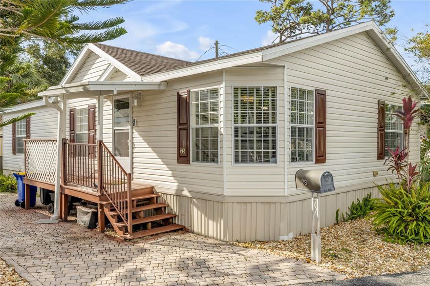 Discover coastal comfort in this well maintained 2-bedroom/2-bath home in a 55+ waterfront community. The home features a screened-in porch, shingle roof year 2021, A/C year 2022, and vinyl plank flooring in the kitchen, bathrooms and laundry room.  The updated kitchen has an over-the-range stainless microwave, sleek French door refrigerator, a stainless double sink with pull-down faucet sprayer and Reverse osmosis water filter. Custom plantation blinds throughout. Floodlight for back yard.   Generous storage shed was just added to the back yard with electric for your tools, hobbies or gear. Located just minutes to New Smyrna Beach. The Friendly Shores community boasts direct water access for fishing or boating, a community center with outdoor seating, a large fishing dock and kayak launch, and low HOA fees that cover water, sewer, trash and common-areas