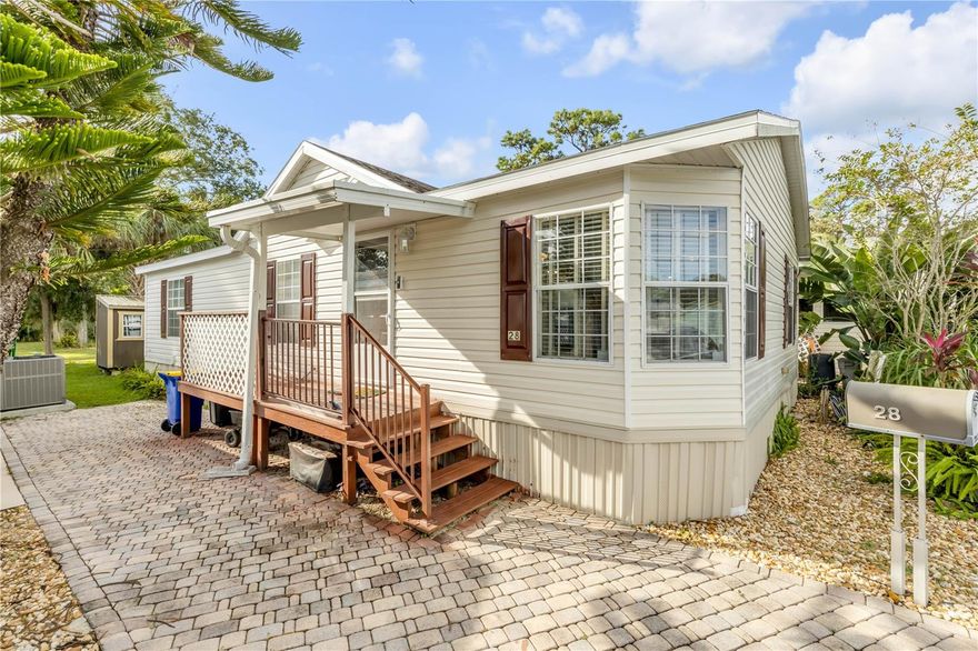 Discover coastal comfort in this well-maintained 2-bedroom, 2-bath home located in a desirable 55+ waterfront community where you own the land. The home features luxury vinyl plank flooring in the kitchen, bathrooms, and laundry room, along with soaring cathedral ceilings that enhance the open feel. Major updates include a shingle roof (2021) and A/C system (2022). The kitchen is equipped with updated stainless steel appliances, including an over-the-range microwave, sleek French-door refrigerator, a double sink with pull-down faucet, reverse osmosis water filtration system, and newly installed pantry cabinets for added storage. Both bathrooms feature updated faucets, and the primary bathroom boasts an updated shower stall complete with a built-in shower seat and light for added comfort and convenience. LED lighting is installed throughout the home, creating a bright and energy-efficient environment. Custom plantation blinds add style and privacy throughout. The home also features a storm door with a convenient pull-down screen, allowing for added airflow and natural light. Step outside to a backyard equipped with a smart floodlight camera compatible with Alexa and Google, along with an 8x10 storage shed with electricity—perfect for tools, hobbies, or extra storage. Conveniently located just minutes from New Smyrna Beach, the Friendly Shores community offers direct water access for fishing and boating, a community center with outdoor seating, a large fishing dock, kayak launch, and low $200 per month HOA fees that cover water, sewer, trash, and common area maintenance. Schedule your private showing today!