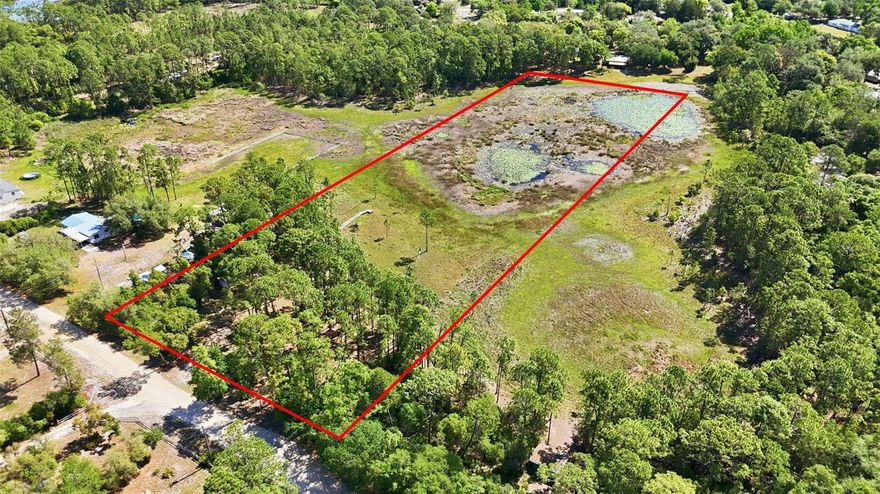 RARE FIND! This unique property located in NE Eustis represents a versatile opportunity, particularly given that the foundational infrastructure like the 240-foot deep well and electricity is already established. With nearly five acres of land and a zoning designation that allows for two dwellings, you have the rare flexibility to construct a primary stilt home, tiny home or manufactured home (block construction is possible but may require additional due diligence) while maintaining the option for a secondary ADU or pole barn. The gradual slope of the terrain toward the water is a natural fit for stilt construction, as it provides the necessary elevation for both flood mitigation and unobstructed views of the lake. Positioned on a quiet dead end dirt and gravel road, your oasis should capture lake breezes and possibly utilize the slope for under-house parking or storage.

The recent survey from April 2025 is a critical asset for your planning process, as it clearly defines the wetland and septic setbacks that will dictate exactly where your footprint can sit. Because the driest portion of the lot is near the front street, you might find that placing the home in this area saves on utility trenching costs while still allowing the back of the property to serve as a private waterfront escape. The lack of an HOA combined with the General Agricultural zoning means your plans for beekeeping or small-scale livestock can be integrated seamlessly into the landscape without restrictive oversight. 

No timeframe to build and NO HOA. Since the property is partially cleared, the transition from a vacant lot to a functional homestead is significantly more straightforward than starting with raw, untouched land. The partially cleared sections are perfect for the General Agriculture allowance (bees, goats, cows, horses, chickens, or gardens). All information deemed accurate but should be independently verified. Located within 10 minutes of shopping plaza and 20 minutes to Downtown Mount Dora.