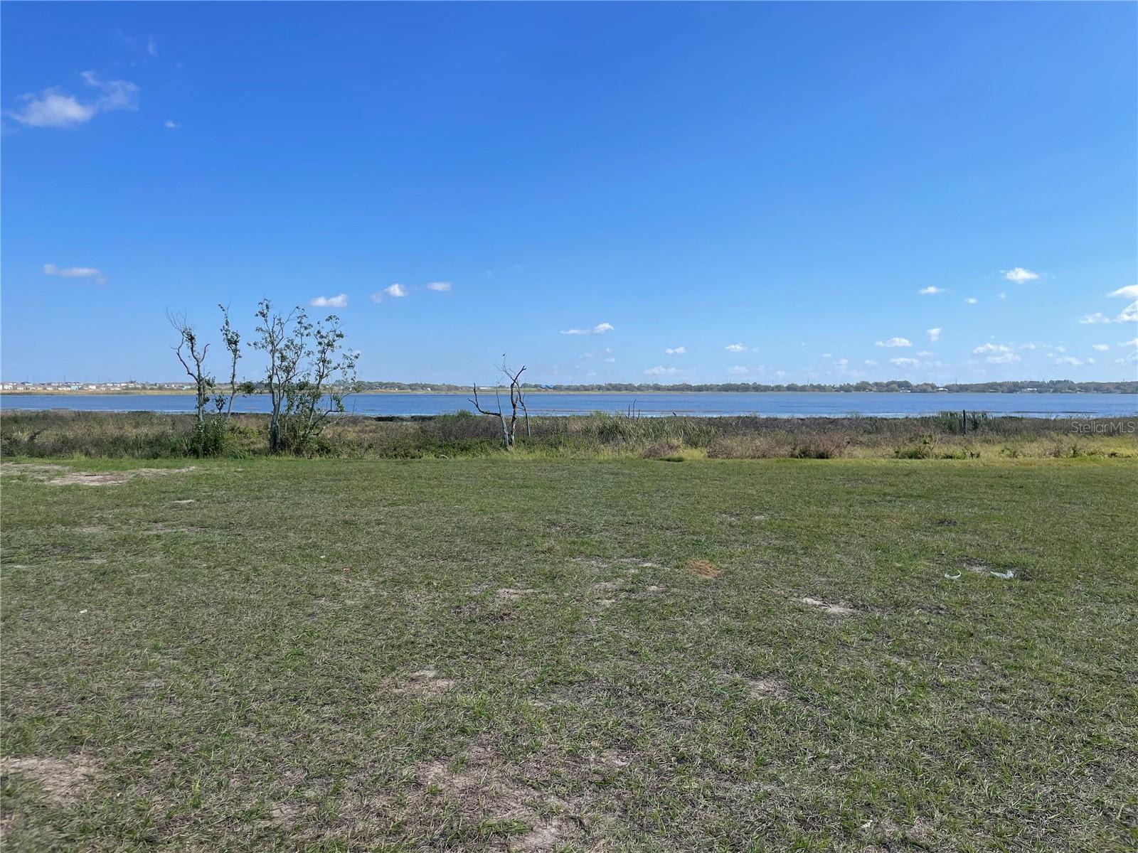 This beatiful,one of a kind lake front property is situated on Lake Alfred and is suitable for a lake front dream house. This property is part of Water Ridge sub divison phase 2. Water Ridge is an upscale, gated community nestled amongst two boating lakes, Lake Alfred and Lake Vann, and a fishing lake Madera. This community provides great amenities like multiple lighted tennis courts, swimming pools, miles and miles of walking trails. It has a state of the art club house and exercise room. For fishing and boating enthusiast it is a paradise. You can even park your boat in the boat parking area. It is only a 10 minute commute to I-4 that make it eaiser to travel to Orlando, Kissimmee, Disney world, Univeral Studio, Seaworld, etc.