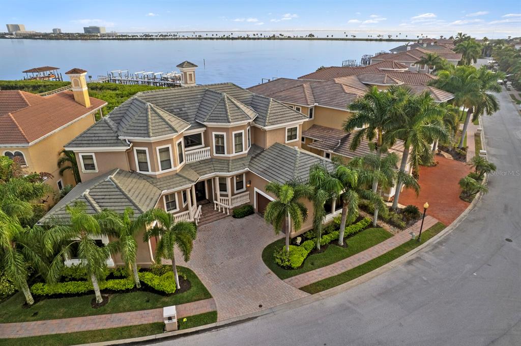 Bayfront living at an extraordinary value in the intimate gated enclave of the Reserve of Old Tampa Bay. Providing quality finishes throughout and stunning Bay views, an impressive double door entry leads to an elegant foyer with soaring ceiling and sweeping staircase, formal living room with fireplace, formal dining room and contemporary office with glass double door entry. The gourmet kitchen offers top-of-the-line stainless appliances, butler’s pantry, center island with prep sink and granite overlooking the breakfast area and family room, with water views beyond. A grand staircase or elevator provides access to a second-floor master suite retreat offering a quiet sanctuary with water views, private terrace, morning kitchen, expansive custom closet and luxurious bath. Additional guest bedrooms offering terrace access and private baths complete the second level. The indoors and outdoors flow seamlessly to a spacious outdoor entertaining area with a pool, outdoor kitchen and private courtyard. Additional appointments include a private boat slip with lift on a common dock and a 3-car garage. Minutes from downtown Tampa, shopping, beaches, Tampa International Airport and Berkeley Prep School (5 minutes). Excellent rental potential.