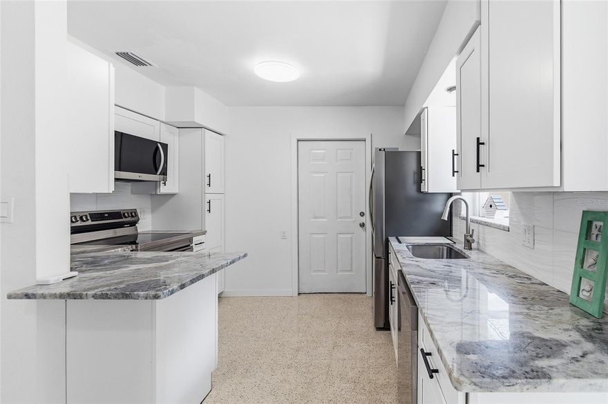 Coastal Retreat in St. Pete – 3BR / 2BA + Garage and Flexible Lease Options | Fully Renovated & Furnished. Welcome home to your slice of paradise on Coquina Key! This beautifully renovated 3-bedroom, 2-bath home with a 1-car garage sits at the end of a quiet cul-de-sac and backs directly up to Coquina Key Park — your backyard oasis with pickleball and tennis courts, walking trails, a fishing pier, kayak launch, playgrounds, open green space, and a free public boat ramp. Inside, enjoy modern coastal comfort with an all-new high-end kitchen featuring granite countertops, stainless steel appliances, and custom cabinets. The home offers polished terrazzo floors, new roof, new HVAC, new ceiling fans, and a brand-new washer and dryer. French doors lead to a large fenced backyard that opens to peaceful park views — perfect for relaxing, entertaining, or watching the sunset. You’re just minutes from Downtown St. Pete, where you’ll find The Pier, Beach Drive restaurants, art museums, local breweries, boutique shopping, and waterfront parks. Spend your weekends exploring galleries, catching live music, or unwinding on the nearby Gulf beaches and Ft. DeSoto Park — this home is the perfect blend of coastal charm and city convenience. Lease Options: Long-Term: $2,700/mo – Lawncare included, tenant pays utilities, $2,700 deposit. Short-Term (4–6 mo): $3,400/mo – Includes all utilities, lawncare, high-speed internet, and exterior security cameras | $1,500 deposit | Fully furnished and thoughtfully equipped with all the comforts and conveniences of home.