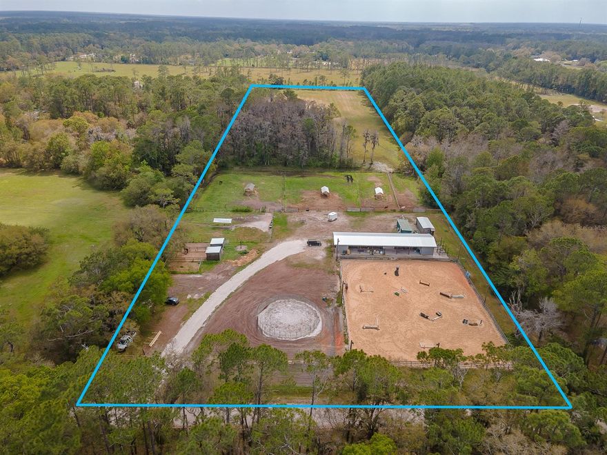 10 acre slice of heaven in the heart of New Smyrna Beach! Impact fees paid, so come build your next dream home or drop a manufactured home and enjoy the peace and serenity. Property also features a 6 stall barn with metal roof, tack room, and riding arena. Newer well and electric hocked up. You have the option to continue to board horses and rent each stall out for $600/mo. Endless opportunities with this property! Fenced and gated!