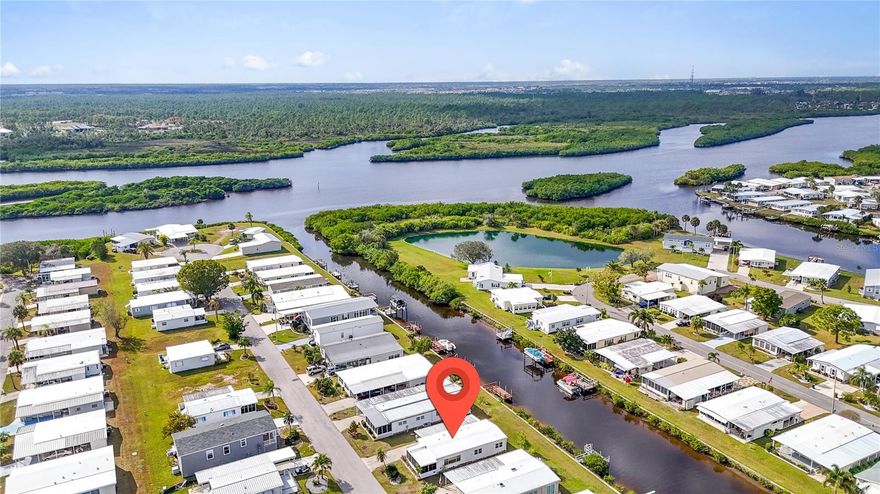 Discover an exceptional value opportunity in this 1152 sq ft, 2-bedroom, 2-bath canal-front home located in a vibrant 55+ waterfront community along the scenic Myakka River. This property is priced to reflect needed exterior repairs to the carport and lanai ceiling/roof. The home’s main roof was installed in 2023 and the AC system and new ductwork in 2024, so those big items are already done. Inside, you’ll find an open concept with huge living area filled with natural light and a spacious remodeled kitchen featuring stainless steel appliances, plentiful white cabinetry with large soft close drawers and granite countertops with breakfast bar. The dining area has more built in cabinetry and countertop space, great for serving buffet style. Wake up to peaceful water views from the primary bedroom, complete with an en-suite bath and walk-in closet, while the bright guest bedroom sits conveniently across from the hall bath with its updated walk-in shower surround. The enclosed 190 sq. ft. front lanai will need some attention, but it offers valuable extra living space and a great additional spot to relax or entertain. This home is partially furnished and has washer/dryer hookups in the shed under the carport. A long driveway provides plenty of parking for guests or extra vehicles. Put a patio or deck in the backyard and transform it into a private waterfront retreat overlooking the canal. Residents enjoy low HOA fees of just $175 per month and an impressive lineup of amenities: a 90-slip marina, two swimming pools, spa, two-story clubhouse, pickleball and multiple sports courts, plus a full calendar of social events and activities. There may be potential to install a private dock or simply rent a boat slip for only $300 per year.  With boating, fishing, golf, shopping, dining and Gulf beaches all within easy reach, this home offers the perfect blend of lifestyle, location, and value. Home is being sold AS-IS. Schedule a showing today to take a closer look!