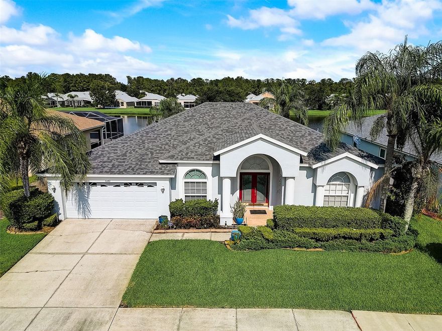 Everyday is a vacation in this spacious home for everyone! This beautiful home boasts a 3-way Split Plan Bedrooms great for privacy, 10' ceilings,  with the fourth bedroom located in its own wing of the house.The gorgeous backyard oasis boasts a crystal blue pool and spa, a covered porch and screened lanai overlooking a serene pond with the kitchen and family room just steps away from your lanai. This home chef's dream kitchen includes an island, double-door pantry, smooth-top range, microwave, tile floors and much more! The owner's bedroom suite enjoys ample space and beautiful views of an exterior escape through sliding glass doors, complete with an oversized walk-in closet, a larger-than-normal shower and a lovely garden tub. Newer roof, air conditioner and numerous updates throughout this home makes it just right for the new owner. Lexington Oaks is an 18-hole golf course community with a golf club and restaurant, also includes a rec center, park, playground, 2 swimming pools, and a day care center. Enjoy living in this beautiful landscaped community with lower Pasco County taxes.  This community is conveniently located near I75, Wiregrass Mall, Shopping, Restaurants, and downtown Tampa. You will love this triple Split Floor Plan and the ample square feet, with so many areas to retreat to if privacy is what you seek.