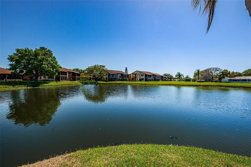 TRANQUILITY AND SERENITY with unobstructed VIEWS of the waterway running through this well maintained, MAINTENANCE FREE 55+ community. This upper level split floor plan condo features 2 bedrooms, 2 baths, 1144 square feet with a covered carport plus storage closet in the carport area. The gathering room is open and airy with sliding glass doors to the back balcony overlooking the sprawling greenbelt area and water. There are views from almost every room in the home. The updated kitchen is in the front of the home with sliding glass doors to your own private front balcony, perfect for enjoying your morning coffee or breakfast before you start the day. The kitchen features ceramic tile floors, crown molding,  a newer dishwasher and refrigerator (2021), range, microwave, pantry and full size laundry closet including the washer and dryer and storage shelves. The entire condo was just newly painted with a popular neutral color. The primary bedroom is located at the back of the condo and features views of the water, a large walk-in closet, private bath with a walk-in shower. The secondary bedroom is in the front of the home with easy access to the second bathroom which includes a shower/tub combination and new medicine cabinet. Additional features include a brand new HVAC unit with a transferrable warranty (5/2023), Roof (2014) which is covered in your HOA dues, large storage closet off of the dining area and a newer water heater. Beacon Lakes is a 55+ community located in a prime location with a tropical, Florida ambiance that is popular with the residents. It includes a community clubhouse, pool and hot tub, Bocce ball and Shuffleboard court, fitness room, library and pool table along with community clubs and activities as outlined in the community newsletters. It is a wonderful place to call home and to enjoy Florida living. It is close to restaurants, beaches, golf courses, parks, shopping and so much more. Low monthly HOA dues includes maintenance free community, roof, cable TV, internet, trash, water and all of the above mentioned amenities. THE VIEWS MAKES THIS CONDO A PERFECT PLACE TO CALL HOME FOR FLORIDA LIVING.