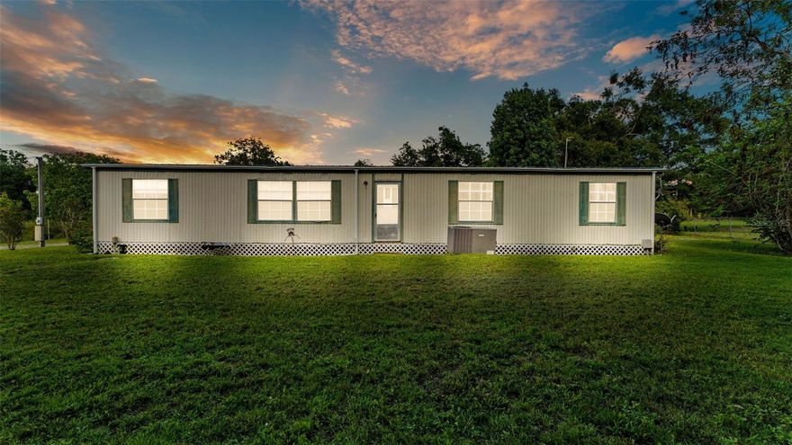 Tucked away on a peaceful 2.87-acre flag lot in Mulberry just off County Line Road, this unique property offers a rare blend of privacy, nature, and functionality. The long extended driveway sets the home back from the main road, so you’ll enjoy seclusion and quiet, no road noise. The mobile home is dated but livable, making it a great opportunity for someone looking to move in right away or update at their own pace. The land itself is the real standout- lightly wooded with mature trees, a pond frequented by ducks, and an impressive variety of fruit and flowering plants. You’ll find several shampoo ginger plants aka the pinecone lily, pecan tree, avocado tree, kumquat tree, and many pineapples, along with guava bushes, sugarcane and a surinam cherry bush already rooted and producing. All add unique character to the landscape, making the property a true haven for gardeners and nature lovers alike. Birdwatchers will also appreciate the abundance of wild birds that frequent the property. Other features include an RV hookup, a shed for storage, and a workshop, giving you space for hobbies, tools, or equipment. Whether you’re dreaming of a peaceful homestead, a place to park your RV, or room to expand, this property offers endless potential to make your vision a reality.