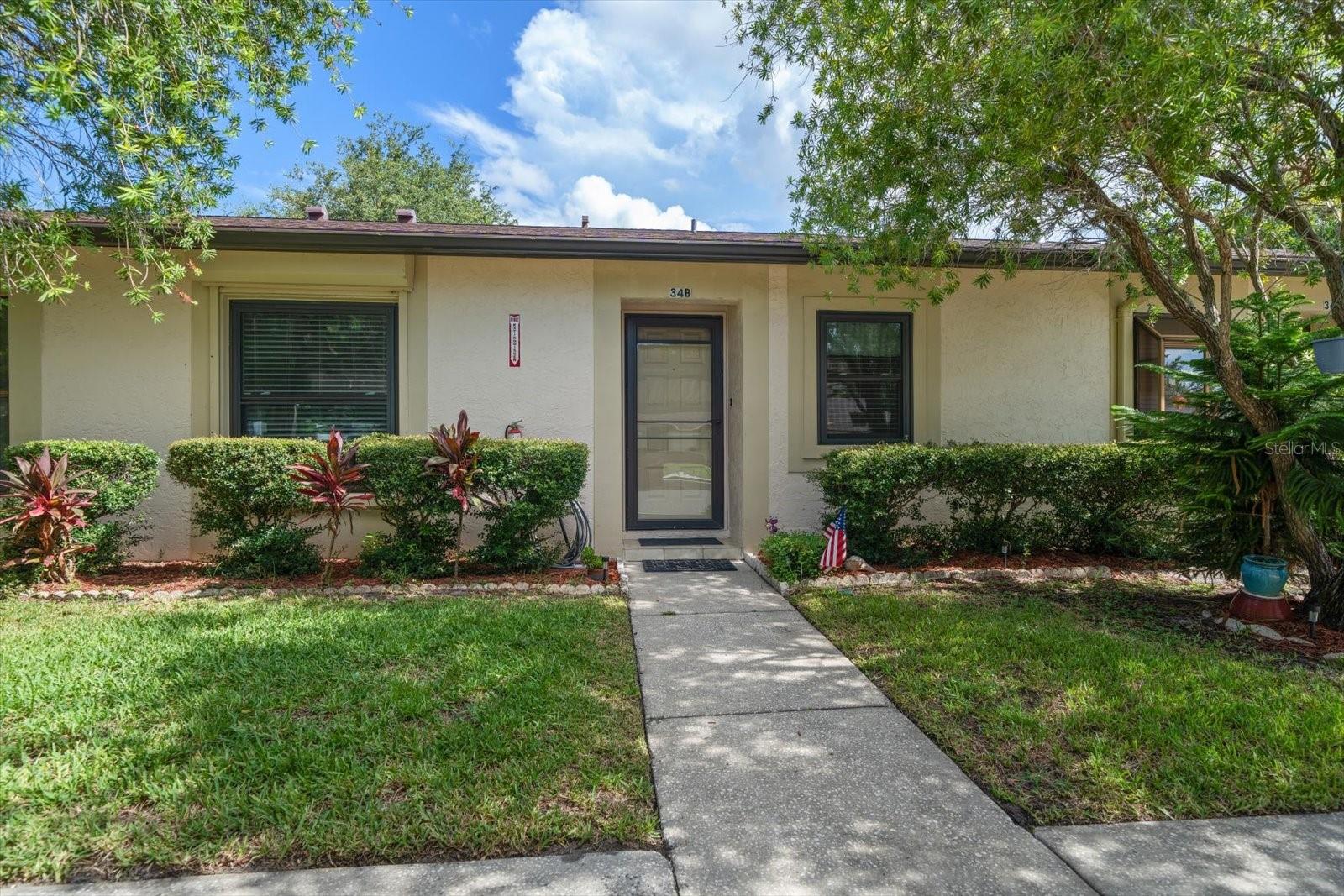 Welcome to effortless Florida living in this beautifully remodeled 2-bedroom, 2-bathroom split floor plan condo located in the highly desirable, all-ages, pet-friendly community of Deerwood Gardens. Step inside to discover a bright, open living space with vaulted ceilings and durable tile flooring throughout the main areas. The spacious Florida room offers serene views of the patio and the community tennis courts, bringing the outdoors in. The kitchen has been tastefully updated with granite countertops, stainless steel appliances, and rich solid wood cabinetry—perfect for both everyday cooking and entertaining. Retreat to the private primary suite featuring luxury plank vinyl flooring, a walk-in closet, and an updated ensuite bathroom. The second bedroom and bathroom are equally well-appointed, ideal for guests or a home office. Enjoy the convenience of a full-sized washer and dryer inside the unit and the peace of mind that comes with hurricane-impact windows and sliders, plus exterior pull-down shutters for added security. Major systems have been updated, including a new A/C in 2020, a water heater in April 2022, and a brand-new roof in 2025. Deerwood Gardens offers fantastic community amenities, including a heated pool, shuffleboard, tennis courts, and a clubhouse. This unit has 2 covered parking spots right out front. The home has been beautifully decorated and all furnishings are optional. Whether you're looking for a year-round home or a seasonal escape, this property checks all the boxes. Don't miss this opportunity to own a low-maintenance, high-comfort condo in a welcoming and well-maintained community!