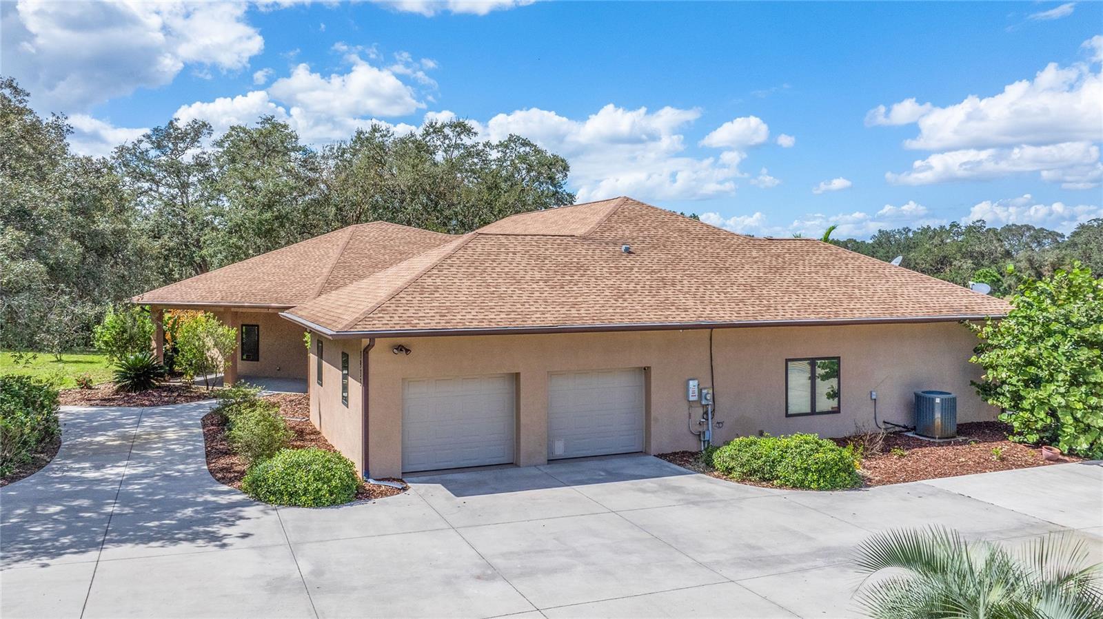 This impressive 5-acre ranch pool home, built in 2016 is a zero-energy residence constructed with ICF (Insulated Concrete Forms) for superior thermal efficiency and sound insulation 12 inch thick, energy sustainable ICF Fox Blocks! 5 acre ranch built in 2016 is a zero energy home with dual RV garage and workshop, cross fenced and zoned for horses. The entry way drive is gated with electric opener. This amazing architectural design includes tray ceilings throughout the home with 10’8” ceilings and a well planned thought out split bedroom floor plan with a 23 x 23 octagon great room beautifully designed with matching octagon tray ceiling inclusive of integrated digital mood lighting and crown molding, in fact crown molding throughout this lovely home. Hand Crafted Custom built bookshelves in Library and in the separate office. Beautifully designed kitchen with Quartz counter-tops, two garbage disposals (1 in the Island sink and the other in the main sink) with all lower cabinetry pull-out-drawers, two Walk-in Pantries (1 in the immediate kitchen area, the other in the garage for overflow storage). The primary bedroom and ensuite bath is incredibly large inclusive of a sitting area, double mood lighted tray ceiling and crown molding, (2) walk-in closets (his & hers) with the large closet 10.8 x 14 with built-ins. The primary bath includes a large garden tub, large walk-in shower stall and is facilitated by its own hot water heater. Bedroom 2 also has its own bath with a garden tub and separate shower stall and it also is facilitated with its own hot water heater for the bedrooms on the other side of the home.. This residence is constructed with ICF (Insulated Concrete Forms) with 6” reinforced concrete exterior walls sandwiched between two layers of insulation forming 12” thick walls which provide superior thermal efficiency, sound mitigation and 200 MPH wind resistance. An R-value of 23.5+ plus whole-wall high performance enables a Zero Energy Ready residence. Continuous Natural Vapor Barrier create space with healthier air quality. PERM rating of <1.0, virtually eliminating moisture intrusion, mold and rot. This is also an “Aging in Place Home Design” totally handicap accessible. 3 separate heating and cooling zones controlled by a single digital pad on a single 4 ton, 15 seer A/C system which utilizes minimal energy, Pella Double Insulated windows with enclosed blinds. The home is an all-electrical home and the Solar panels are located on top of the detached 40 X 60 dual RV garage and not on the home eliminating any roofing or shingle issues. The RV garage has (2) RV stalls with (1) stall is a drive-through with the rear door 12’x12’. The 2 front RV doors are 12’ wide x 14’ high and the building is entirely insulated and structured with galvanized steel framing and 20 foot ceilings, has its own electrical panel for your RV needs. Utility bill for electric averages $33.88 a month and that cost is only for storage and transmission of energy to and from Duke Energy. Pool solar panels at ground level are for heating the pool with year-round swimming. The in-ground pool concrete with separate spa and electric heater all entirely screened enclosed. 2 10x20 steel storage containers located directly behind the RV garage and not visible from anywhere in the front of the home. Superb location high and dry with like-kind acreage homes. Looking for an energy sustainable home with acreage, this is it! Call today to view this amazingly built home!
