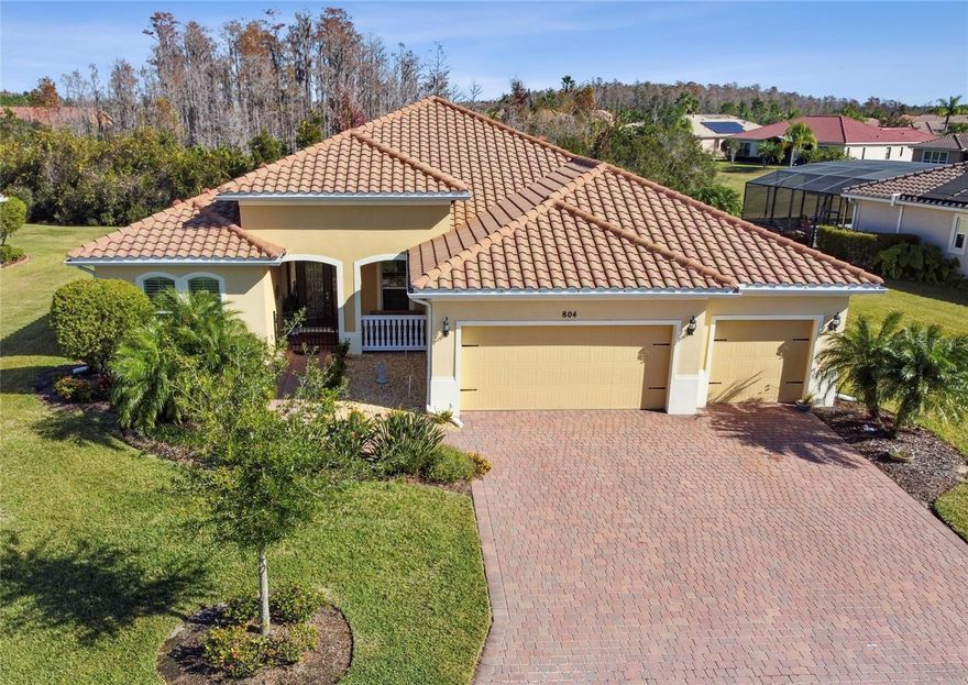 NEW PRICE!! NEW HVAC INSTALLED SEPTEMEBR 2025. Welcome to this stunning Pesaro model in the exclusive Portofino Estates of Solivita. Situated on an oversized lot with a THREE-CAR garage, this home offers exceptional privacy and plenty of room for a future pool. The expansive outdoor space is complemented by a convenient lanai half bath, perfect for entertaining. Enter through the gated front porch and step into a thoughtfully designed floor plan featuring 3 bedrooms, 3 full baths, plus a DEN, along with the OUTDOOR HALF BATH. TALL CEILINGS and ceramic tile flooring throughout the main living areas create a bright, open, and welcoming atmosphere.The owner’s suite is a true retreat, showcasing LVP FLOORS, plantation shutters, two custom walk-in closets, and private French door access to the lanai. The ensuite bath boasts DUAL GRANITE vanities, a walk-in shower with dual bench seating, a private commode, and a large linen closet. The gourmet kitchen is designed for both style and function with 42" solid wood cabinets, granite countertops, STAINLESS STEELL APPLIANCES, recessed lighting, and a center island with seating. A closet pantry and adjacent breakfast nook flow seamlessly into the family room—ideal for everyday living or entertaining. The split bedroom layout ensures privacy for guests, with two additional bedrooms featuring plush carpet and plantation shutters. A dry bar with lockable cabinets, a large laundry room with washer, dryer, stainless steel sink, and extensive storage add to the home’s functionality. Upgrades include: custom blinds, PLANTATION SHUTTERS, upgraded lighting & fans, 8' doors and sliders, higher baseboards, and a leaded glass entry door with sidelights. The 3-car garage offers a utility sink, WHOLE-HOUSE WATER SOFTENER, and pull-down attic stairs. EXTERIOR PAINTED IN 2019. Solivita's amenities include: * - a manicured SOFTBALL diamond & field - 36 holes of CHAMPIONSHIP GOLF that can be played by joining the Stonegate Golf Club or paying as you go - 2 STATE of the Art AMENITY centers with updated exercise equipment, yoga studio & meeting rooms - 3 restaurants - 14 HEATED POOLS - 17 PICKLEBALL courts - 9 TENNIS courts - 4 BOCCE BALL courts - 4 SHUFFLEBOARD courts - 3 HORSESHOE. Click on VIRTUAL TOUR link 1 to see MATTERPORT 3D VIDEO and virtually walk through this home. Solivita is an AWARD winning 55 plus community boasting over 4200 acres of natural beauty -come and enjoy retirement living at its finest. Call and schedule your private viewing and make it yours today!