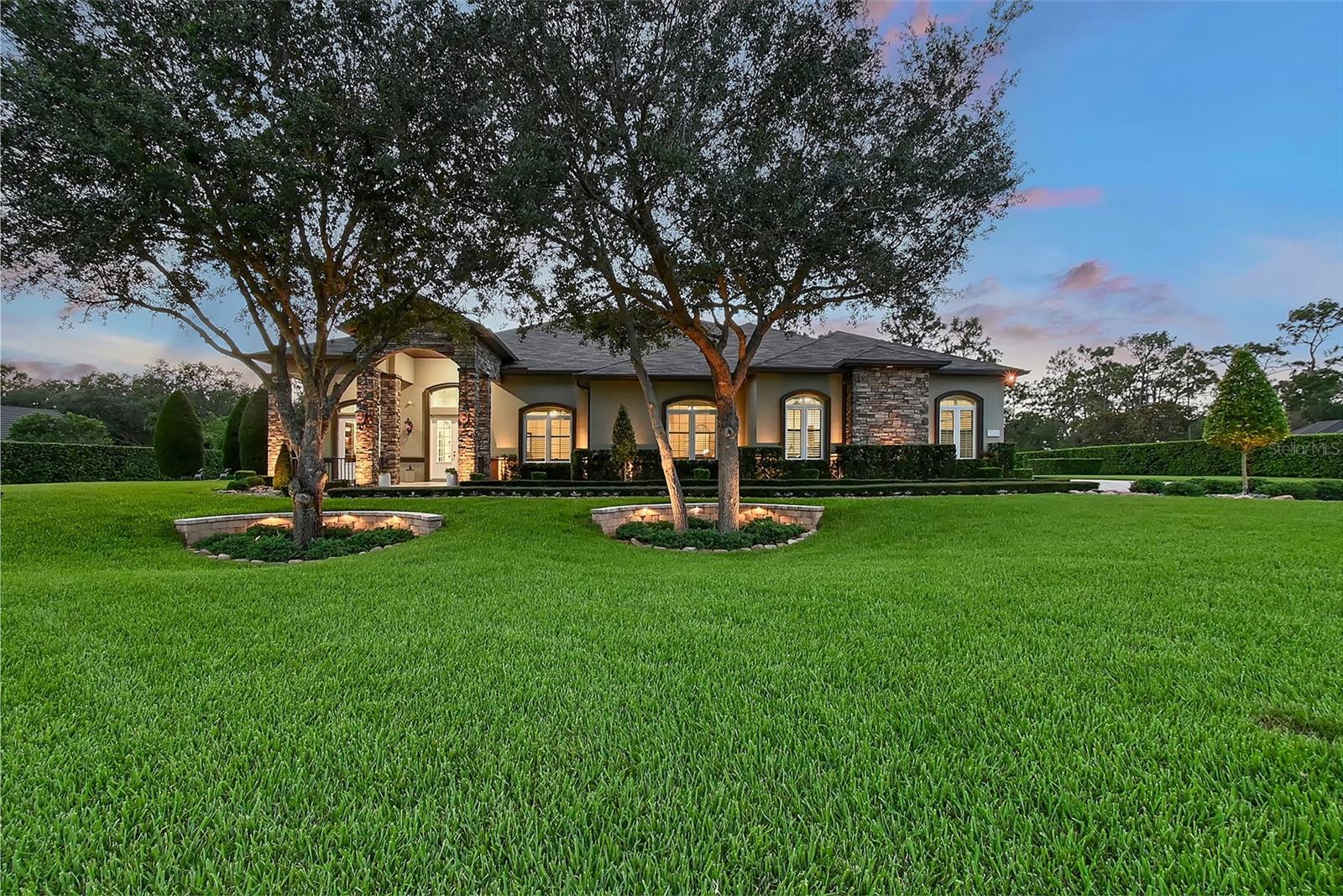 Welcome to this extraordinary country estate where custom craftmanship combines with beauty and functionality on a pristinely landscaped and manicured 1.3-acre lot, bordered by a nature preserve. This custom residence built by Vision Home Builders is positioned on one of the most beautiful lots in the Preserve at Panther Ridge. All of the elements of this home have been thoughtfully curated to combine natural, imported materials with modern conveniences, all nestled in the heart of a spectacular natural setting. Natural stone exterior trim greets you as you approach the home. Some of the premium features of this home include an executive office with custom Italian tile flooring and a separate entry to the front of the home, for convenience or to provide privacy if used as a 4th bedroom, plus 12-foot ceilings and solid wood doors and porcelain tiling throughout the home. For your peace of mind, Hurricane rated impact windows and doors are featured throughout the home, along with a whole-house Generac 24kw generator, and monitored security system. Utilities services include a huge, 500-gallon propane tank, whole-house water filtration system with UV light, extra deep well for clean reliable water, dual AC units and 2 tankless water heaters. This home is built for wonderful family gatherings or entertaining in the functional gourmet kitchen with gorgeous granite countertops, KitchenAid stainless steel appliances, double-ovens, two dishwashers and oversized refrigerator and a large island that provides extra storage for all your cooking essentials. The kitchen area also includes a separate service area with a pass-through to the lanai for those casual evenings outside. Adjacent to the kitchen is an additional butler pantry/back kitchen with refrigerator, cooktop, granite counters, cabinetry, service sink and washer and dryer. The 3-car garage is oversized, with epoxy flooring and custom cabinet storage and includes a huge retractable awning for washing your car or just providing shade for relaxing outside. The primary suite is beautiful with plantation shutters and gorgeous views of the pool and natural setting. All baths include premium marble countertops and premium cabinetry and the finest of finishes. Outdoor entertaining starts with the disappearing sliding doors, which open the entire house to the expansive outdoor setting. The covered area includes wood finished ceilings, tile flooring, a cozy gas fireplace and UV remote controlled sunshades with ambient lighting, for those days you want a bit more shade. The 48' x 18" travertine deck surrounds the PebbleTec heated, salt-water pool with a sundeck for sunbathing and relaxing. The 1.3-acre property is pristinely manicured and designed to be a haven for enjoying this beautiful, natural setting. Stone pathways, plant beds, customized landscape lighting, outdoor seating areas with natural stone decking and a huge fire pit. Natural beauty combined with premium finishes, state-of-the-art functionality, and unrivaled peace and privacy to make this resort-like home a respite for heart, soul, mind and body. The Preserve at Panther Ridge, where nature abounds, offers 15 miles of hiking, and horseback, trails, tennis courts, fishing ponds and a kid's park. Panther Ridge is a 4,500-acre community with that's just outside of Lakewood Ranch, the Nation's Top Master Planned, and Multi-Generational Community!