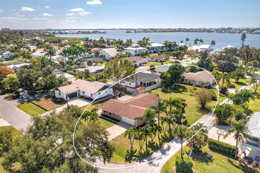 Under contract-accepting backup offers. Welcome to coastal living near the bay! This beautifully maintained home is just moments from the world-famous sands of Siesta Key. Inside, you’ll find a bright, open layout with tile flooring throughout, creating a clean and cohesive flow between the spacious living and dining areas. The kitchen features solid cabinetry, a breakfast bar, and stainless steel appliances, with plenty of counter space for meal prep. Natural light fills the home through large windows, highlighting the comfortable bedrooms and updated bathrooms designed for easy everyday living. Step outside to enjoy the large screened-in lanai, a perfect spot to unwind, dine outdoors, or simply take in the peaceful surroundings. The expansive backyard offers endless potential, whether you envision a garden, pool, or additional outdoor entertaining area. Enjoy being minutes from Siesta Key Beach, waterfront dining, parks, marinas, and vibrant shopping and entertainment in downtown Sarasota. The neighborhood’s friendly, laid-back coastal vibe makes it ideal for those seeking both relaxation and access to all that Sarasota has to offer. The property is on a spacious lot with mature tropical landscaping and offers ample parking with a two-car garage. A brand new water heater was installed in 2025.  Whether you’re searching for a full-time residence or a seasonal getaway, this Sarasota gem offers the perfect combination of comfort, convenience, and proximity to the coast. Come experience the Florida lifestyle just minutes from the bay and Siesta Key! **THIS PROPERTY QUALIFIES FOR A 1% LENDER INCENTIVE IF USING PREFERRED LENDER. INQUIRE FOR MORE DETAILS.**