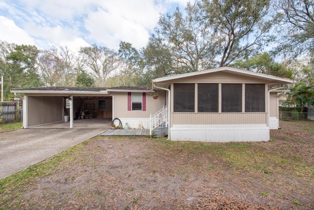 Step into comfort and convenience with this charming manufactured home in the heart of Lakeland, Florida. Boasting 3 bedrooms and 2 bathrooms, this residence offers a cozy retreat with a generous 960 sqft of living space on a sprawling .28-acre lot. Privacy is paramount with a fully fenced-in yard, providing a secure haven for both relaxation and play. The property features a convenient shed, perfect for additional storage, and 2 car ports to protect your vehicles from the Florida sun. Inside, revel in the modern touches that elevate this home. The flexible storage room provides versatility, while the new laminate flooring throughout exudes contemporary style. The kitchen is a culinary delight with stainless steel appliances, ensuring both functionality and aesthetic appeal. Stay comfortable year-round with the benefit of a newer AC system. Embrace the Florida lifestyle on the screened-in front porch, creating an ideal spot for morning coffee or evening gatherings. For nature enthusiasts, a short walk takes you to Gator Creek Park, offering outdoor activities and scenic beauty. This location also provides easy access to I-4, making trips to Orlando or Tampa a breeze, each within a 30-45 minute drive. Convenience is key, as the property is situated just off 98, providing a quiet oasis while maintaining proximity to shopping and the vibrant restaurant scene in Lakeland. Experience the best of Florida living in this well-appointed manufactured home. Roof is from 2015.