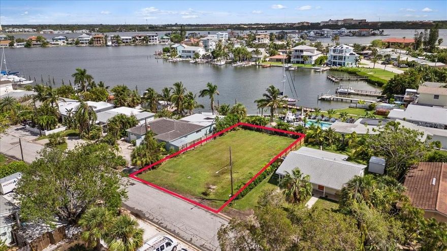 Discover the perfect canvas for your dream home at 14033 E Parsley Dr, Madeira Beach. This prime vacant lot offers an exceptional opportunity to build a custom residence with stunning water views. You'll enjoy the tranquility of coastal living while still being conveniently close to local amenities and the vibrant charm of Madeira Beach. Whether you envision a modern waterfront retreat or a classic coastal abode, this lot provides the ideal setting to create your perfect sanctuary. Don't miss this rare chance to make your dream home a reality in one of the area's most sought-after neighborhoods.