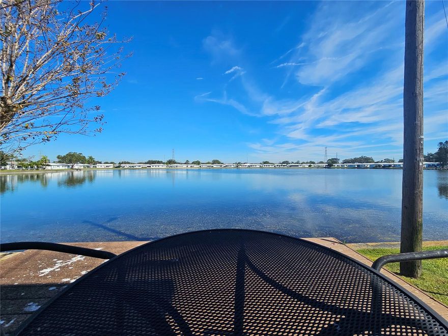 WATERFRONT LIVING IN STYLE… ENJOY YOUR NEW HOME IN THIS ACTIVE 55+ COMMUNITY JUST MINUTES FROM ST PETERSBURG & CLEARWATER!!  Recently remodeled, you will love the panoramic waterfront views and gentle sunrises every day from the comfort of your kitchen, dining area, family room and coffee bar — a serene backdrop that sets the stage for peaceful mornings and relaxing afternoons. The setting is truly unique, offering a sense of escape and connection with nature right outside your door.  This beautifully updated home features two spacious bedrooms and two modern bathrooms. Extensive renovations over the past three years make this residence shine including an updated kitchen with newer appliances, luxury vinyl flooring throughout and fully renovated bathrooms including widened doorways in the primary bathroom to allow easy accessibility.  All doors and hardware have been replaced, five new ceiling fans bring comfort and beauty, and every window is adorned with custom blinds for privacy and style. The exterior includes a new awning, new gutters and soffits, and custom concrete curbs that frame lush flower beds and thoughtful landscaping. A brand-new tile roof, courtesy of the HOA, delivers lasting durability and protection and the new HVAC system and enhanced safety features – among other finishes – give additional peace of mind.   Additionally, if you are looking for an active, centrally located retirement community where you can easily make friends and visit family, “The Mainlands” is for you!  Participate in community breakfasts, bingo, dances, and more at the vibrant clubhouse and pool just blocks away. Golf enthusiasts will appreciate the nearby public course, and pet owners can enjoy strolls with their companions. Personal golf carts are welcomed, making it easy to visit local shopping, Freedom Lake Park, and explore everything the neighborhood offers.  Centrally located, you’re just minutes from Tampa and St. Pete/Clearwater airports, superb dining, shopping, and the breathtaking Gulf Coast beaches. The monthly maintenance fee covers a comprehensive range of services, from roof and exterior painting, water, sewer, trash, basic cable and internet, to full lawn care and clubhouse/pool upkeep. This all-inclusive approach means you can spend more time embracing the lifestyle you love so CALL TO SCHEDULE YOUR SHOWING AND MAKE THIS YOUR NEW HOME TODAY!!