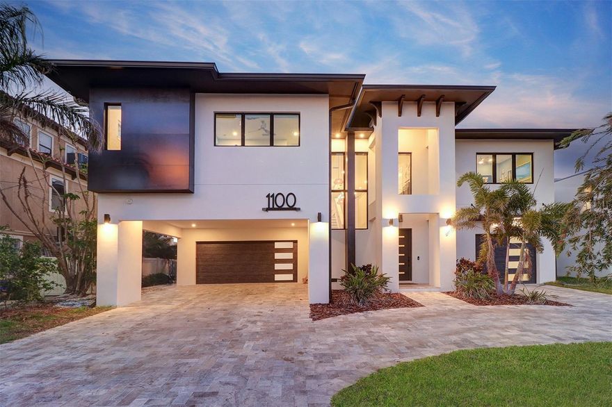 NEW PRICE.......18FT ELEVATION -CUSTOM BUILT WATERFRONT POOL HOME. Welcome to an unparalleled luxury residence that redefines elegant living. This stunning custom-built home, completed in 2022, is a masterpiece of design and craftsmanship, exceeding all fema building regulations. Nestled in an exclusive neighborhood, this 4-bedroom, 3 1/2 bathroom estate features all masonry block construction,Steel and concrete floor trusses providing not only exceptional durability but also a sophisticated aesthetic with high quality imported wood-look tile throughout. The striking elevation showcases an impressive façade adorned with refined architectural elements, creating an inviting first impression. Step inside to be greeted by an expansive open floor plan, bathed in natural light and highlighted by high tray ceilings and exquisite finishes. The grand living area seamlessly flows into a state-of-the-art gourmet kitchen, complete with premium stainless steel appliances including an induction Miele cooktop, elegant and maintenance free waterfall Curava countertops and custom cabinetry—ideal for the discerning chef and perfect for entertaining sophisticated gatherings. Each of the 4 generously sized bedrooms is a sanctuary of comfort, with the opulent primary suite offering a private retreat. Indulge in the luxurious ensuite bath, featuring dual vanities and toilets, a deep soaking tub, and a spacious rain shower, all crafted with the finest materials for an unparalleled spa-like experience.
The additional bathrooms are equally impressive, blending functionality with high-end design. Outdoors, the meticulously landscaped grounds with the resort like pool complete with a beach-entrance provide a tranquil escape, with a lavish travertine covered patio that invites you to savor serene evenings or host extravagant outdoor soirées with breathtaking sunset views. Surround sound and even underwater speakers in the pool. Lots of room for hobbies, storage etc. in the downstairs area. A 51 solar-panel system powers the entire home including the pool and EV charger. Oversized garages, carport and driveway provide parking for up to 11 vehicles.
Situated in a prime location, this home is just moments away from the world famous St Pete Beach  unigue shopping and one-of-a-kind  restaurants ensuring the perfect balance of luxury and convenience. Don’t miss the opportunity to experience this exceptional property, schedule your private showing today and step into a world of refined elegance! Bring your pickiest Buyer this home will not disappoint.