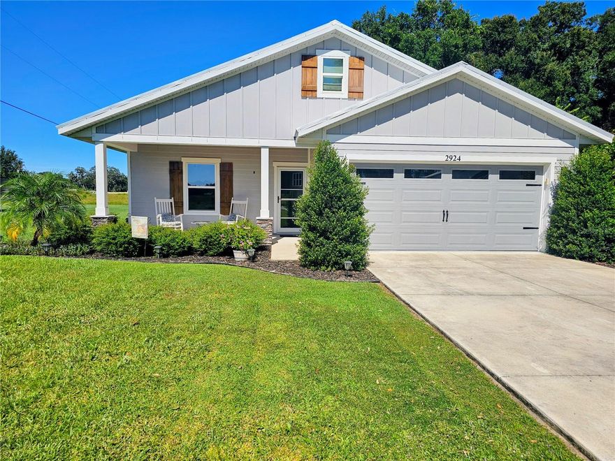 Don’t miss this beautiful 3-bedroom, 2-bathroom custom home with a 2-car garage, set on over half an acre. Built with comfort and style in mind, the open floor plan features high ceilings, modern finishes, laminate and tile flooring throughout, and a bright, welcoming living space. The kitchen includes granite countertops, a large island, ample cabinet space, and high-end stainless steel appliances.

The spacious owner’s suite offers a walk-in closet and private bath with dual vanities and a large tiled shower, along with a beautiful pine ceiling that adds warmth and charm. Two additional bedrooms, a separate laundry room, and open living and dining areas provide function and flexibility. Outdoor features include a screened back porch with pine ceilings and lighting, a front patio with matching finishes, a thoughtfully designed paver-enclosed fire pit, and a beautiful custom matching storage and lean-to shed—perfect for tools, toys, or extra storage.

Enjoy the freedom of a spacious 0.55-acre lot with plenty of room for RVs, outdoor projects, or future additions. Located near The Villages and Bushnell, with easy access to highways, shopping, and more.