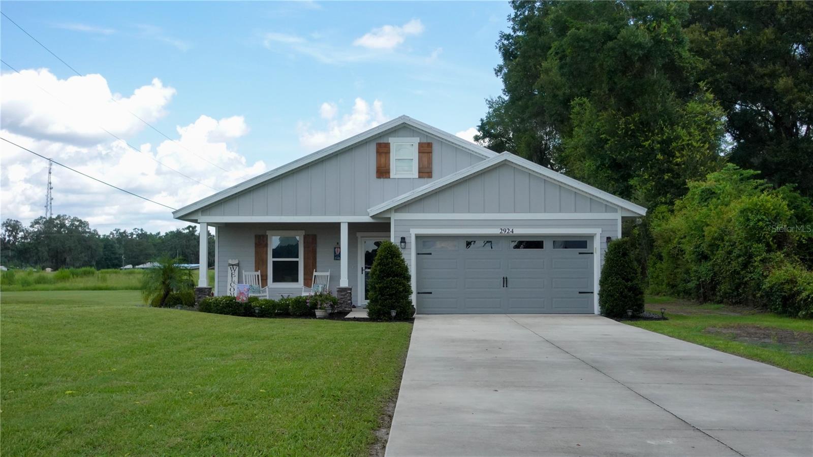 Don’t miss this beautiful 3-bedroom, 2-bathroom custom home with a 2-car garage, set on over half an acre. Built with comfort and style in mind, the open floor plan features high ceilings, modern finishes, laminate and tile flooring throughout, and a bright, welcoming living space. The kitchen includes granite countertops, a large island, ample cabinet space, and high-end stainless steel appliances.
The spacious owner’s suite offers a walk-in closet and private bath with dual vanities and a large tiled shower, along with a beautiful pine ceiling that adds warmth and charm. Two additional bedrooms, a separate laundry room, and open living and dining areas provide function and flexibility. Outdoor features include a screened back porch with pine ceilings and lighting, a front patio with matching finishes, a thoughtfully designed paver-enclosed fire pit, and a beautiful custom matching storage and lean-to shed—perfect for tools, toys, or extra storage.
Enjoy the freedom of a spacious 0.55-acre lot with plenty of room for RVs, outdoor projects, or future additions. Located near The Villages and Bushnell, with easy access to highways, shopping, and more.