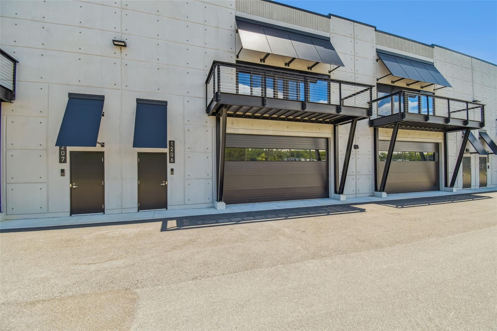 The Motor Enclave is the largest private garage community in the world. On a sprawling 200-acre property, it is a grand theme park for car enthusiasts. This private garage is 1,435 square feet overlooking the heart-pounding excitement of the racetrack with a private balcony and 25-foot tall ceilings, providing room to add a second level to potentially double the square feet. This blank canvas space can be customized and transformed into a dream workshop, office space or the ultimate man cave, while accommodating seven-plus cars. Inspiration floor plans for buildout can be shared by request. Pre-plumbed water/sewer – to add a bath or kitchen - fire sprinklers, individual HVAC unit on the roof, insulated overhead door with electric opener, and a 6-inch-thick concrete slab that can support 2-4 post lifts or a future construction buildout. Upgrades include a subpanel for charging cars, upgraded the service to 200-amp/3 phase and added shelving and cabinets for a workstation. Motorsport Club membership allows access to the Performance Driving Circuit, a 1.72-mile track designed by world-renowned Formula 1 track designer Hermann Tilke. You can also explore the Off-Road Experience, which has 100 acres of challenging trails with a wide range of surface conditions including rocks, water and gravel. The Vehicle Dynamics Pad is a 2-acre versatile sea of pavement designed to host car shows, defensive driver training, laser-timed autocross and more. Owners have 24/7 access to their individual units along with having opportunity to participate in a wide range of social activities across the property, as networking and socializing at the Enclave is a big part of the experiential automotive community. The impressive, 37,000-square-foot Event Center is ideal for corporate, public and private events. Conveniently at the crossroads of Interstate 75 and Interstate 4, minutes to downtown Tampa and a quick commute to Tampa Airport. Immerse yourself in the thrill of speed at Tampa’s Exclusive Motor Enclave.
