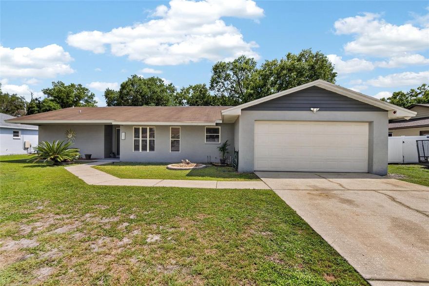 Welcome to this charming 3-bedroom, 2-bath home in the Imperial Lakes neighborhood, with NO HOA! It features a desirable split floor plan that offers both privacy and comfortable living. At the heart of the home is a spacious living room with pocketed sliders that open to a large porch, ideal for relaxing and indoor-outdoor living. The updated kitchen flows beautifully into the living and dining areas and features upgraded cabinetry, granite countertops, a tiled backsplash, and stainless steel appliances. Both bathrooms have been updated, including the primary bath with a double vanity and a large walk-in shower with glass enclosure. The primary bedroom also has its own sliders leading directly to the porch.  Outside, you’ll find a private, fenced backyard shaded by beautiful mature oak trees which is perfect for gardening, entertaining, or simply unwinding. Additional features include a storage shed and a 2-car garage, providing extra space for whatever you need. This home is conveniently located close to shopping, restaurants, and hospitals, and has easy access to major roads for commuting to Tampa, Orlando, or the area's beaches. Stop by and see today!
