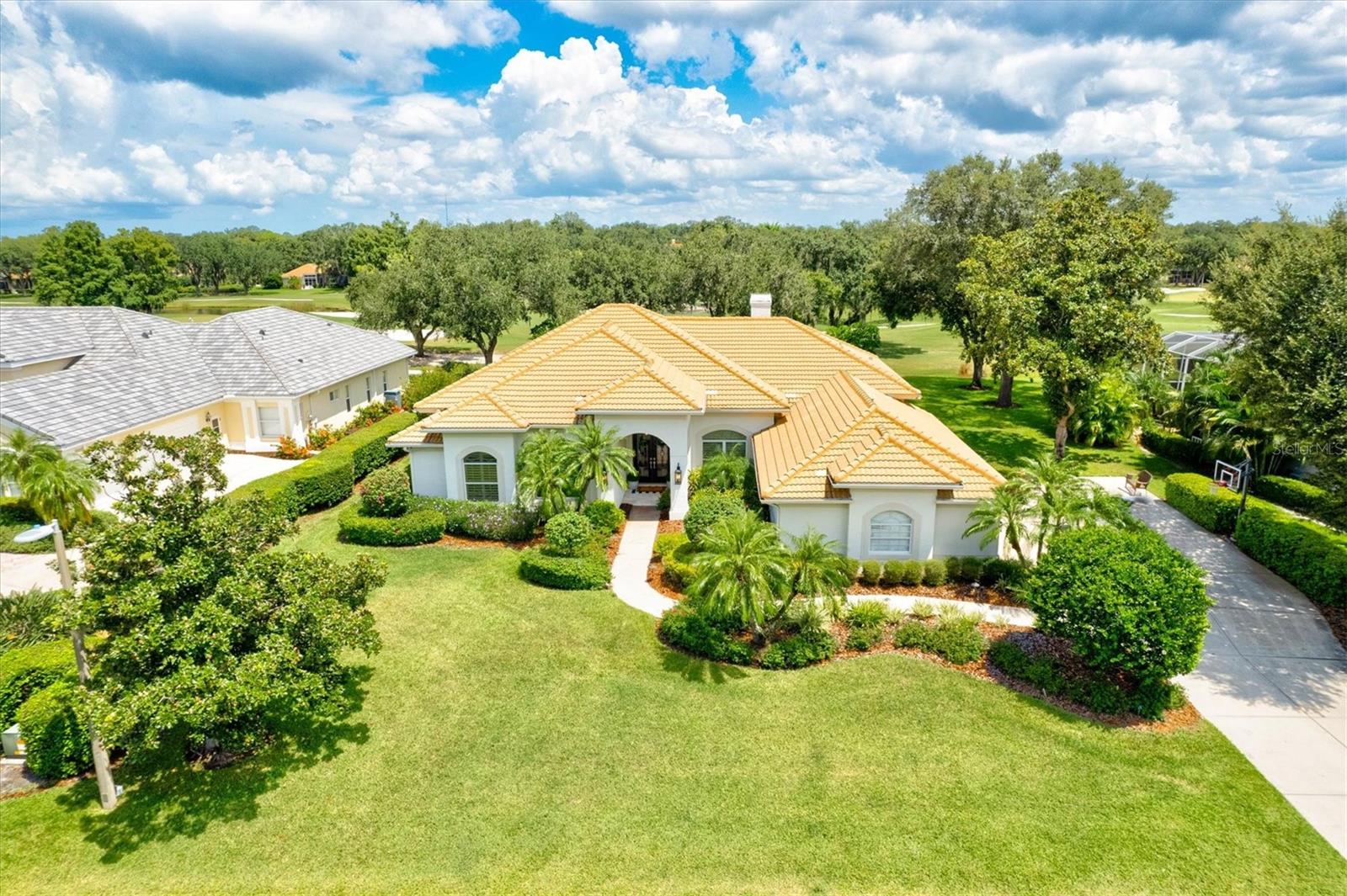 One of the most updated Laurel Oak properties to hit the market! Don't miss this opportunity! Live luxuriously in the desirable Laurel Oaks Country Club. This stunning four-bedroom, four-and-a-half bathroom home will take your breath away. When you open the front doors, you'll first notice the 12 ft ceilings with triple-crown molding and open floor plan. Ample natural light from the 10 ft sliders in the dining and family rooms carry through the home. Lavish upgrades throughout, including Restoration Hardware lighting and custom woodwork. To the right of the foyer, you'll find the elegant front seating room with a coffered ceiling, and to the left, the half bath and hallway to the owner's suite. Beyond the foyer, the home expands to the spacious formal dining space with picturesque golf course views and a 400-bottle wine rack. The gourmet kitchen is equipped with Sub-Zero and Wolf appliances, ensuring the highest quality cooking experience. Custom white cabinetry, quartzite countertops, and a beautiful backsplash add to the luxury of the space. Commercial gas stove top, wine fridge, and a spacious kitchen island adding additional space for entertaining and ample storage. The laundry room, garage access, and large pantry are seamlessly tucked away in the corner of the kitchen. The family room features a stunning modern accent wall with a built-in electric fireplace. The three guest bedrooms are located off the kitchen and family room, each with an attached ensuite and custom closets. Across the home, you'll find the private and spacious owner's suite. Enjoy the serenity of being opposite the rest of the main living space and direct access to the pool and patio through your sliding doors. The extra-large custom walk-in closet doubles as a dressing room that will make you feel like you're in your own department store, with an additional custom closet across the hall. The modern ensuite gives you that spa feeling at home with double vanity, a soaking tub, and a nine-jet rain shower. The owner's suite also features a separate tankless water heater to provide endless comfort. Spend your weekends and afternoons by the pool and spa, or entertain guests in the covered lounge area of your screened-in lanai taking in the views of the Spanish moss-covered oak trees. Looks aside, this home has had all work done so the new owners can begin their fresh start in their new home. Resurfaced pool, newer AC as of 2017, new plumbing and electrical, hybrid water-heater, reverse osmosis water system, and 2013 installed roof. Laurel Oak Country Club is a 24-hour guard-gated community located conveniently in-between Bee Ridge and Palmer just east of I-75. Twenty minutes from downtown Sarasota and area beaches. Private country club membership is available but not required, allowing access to the country club's two golf courses, 12 Har-Tru tennis courts, heated six-lane Junior Olympic pool, driving range, clubhouse, and onsite dining.