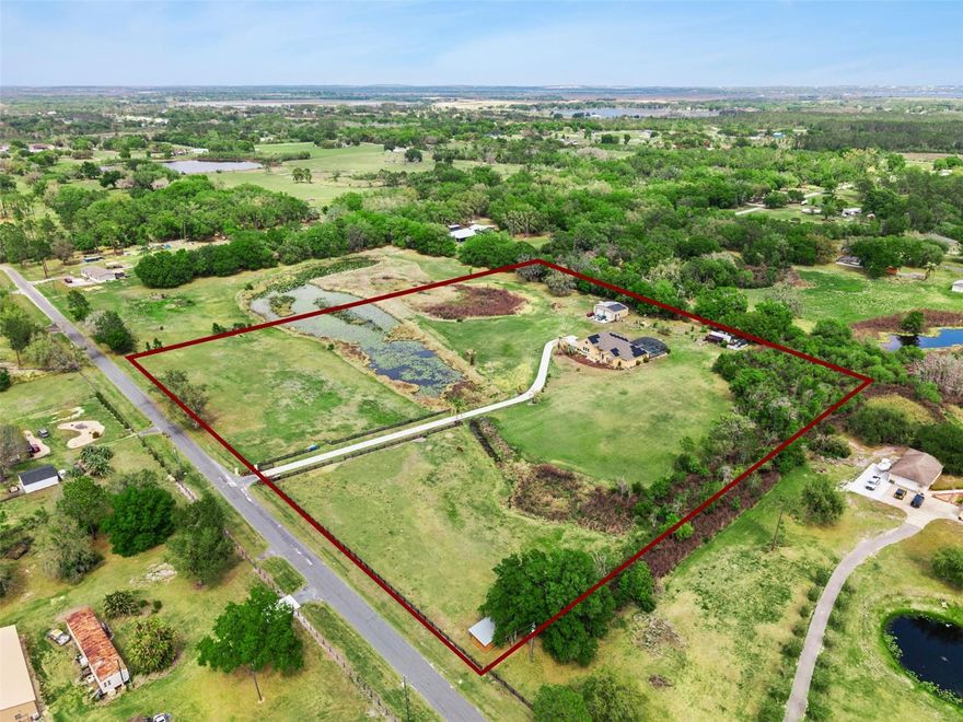 *** GATED 9+ ACRE PRIVATE EQUISTRIAN ESTATE  WITH SCREENED IN SALTWATER POOL AND OUTDOOR KITCHEN/ BAR ENTERTAINMENT AREA *** NO HOA *** MULTI-GENERATIONAL LAYOUT *** STOCKED FISHING POND ***
2024 Roof, 2024 Garage Door. -  
Tired of zero lot lines and HOA rules? This is the escape.
Set behind a private gate on over 9 acres, this custom-built estate delivers what buyers are actively searching for - privacy, security, and complete freedom to use your land your way.
Inside, you’ll find over 3,300 square feet featuring two true primary suites plus a private in-law style suites - with its own full bathroom and separate sitting area. The home has a dedicated office and several modern natural gas fireplaces. This is a rare layout that works perfectly for multi-generational living, long-term guests, or private work-from-home setups.
A well-placed half bath serves guests, while multiple living areas give you flexibility for entertaining or spreading out. The kitchen flows into the main living spaces, creating an open but functional feel.
Step outside and this is where it separates. The outdoor living is dialed in with a screened-in saltwater pool/ entertainment area which includes a full outdoor kitchen with bar - built for hosting. Store your RVs, boats, and trailers or start a workshop in the 30 x 40 metal building constructed on a concrete pad with 2 large roll up doors, insulated roof, 20 amp circuit, fluorescent lighting and plenty of outlets. There is also a 12 x 24 utility shed currently used as a greenhouse for the many fruit trees on the property. In front is a two-stall horse stable and 2 paddocks. Come visit this slice of Southern Charm today! No restrictions. No limitations. Located just minutes from Clermont and major roadways, but tucked away enough to feel like your own private retreat.