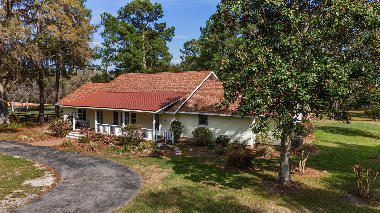Income Producing, Turn-Key Training/Boarding facility with a 2000+ sq. ft. pool home. This gorgeous, manicured property has more amenities than one could ever ask for, and is a complete property, with three barns boasting 35 stalls, a 3 bedroom, 2 1/2 bath charming farmhouse, two arenas, three wells, three septics, a jump field and 21 paddocks, you and your horses will want for nothing. All paddock fencing is new within the past two years, two 13-stall block barns constructed in 2022 are complete with bathroom, laundry, their own electric meter, well, septic and two RV parking pads each. The 12x12 stalls are equipped with auto-waterers, fans, mats and hurricane shutters. Both barns can be completely isolated from storms with roll-up doors at each end. The matted grooming areas have hot/cold wash racks and a 100'x200' sand/clay arena sits just outside of the barns. Two concrete shavings bins service the lower barns and a hacking trail connects the barns to the conditioning/jump field in the back half of the property. The house and 9 stall barn sit at the top of the property. We love the farm-house charm, with vaulted tongue and groove wood ceilings, an open, split floor plan, french doors that lead to the screened in Lanai and pool, indoor laundry and a beautiful kitchen with granite counters, stainless appliances, gas range and an eat-in extended bar. The Owner's Suite has room for a King bed and dresser, a giant walk-in closet, and bright, airy bathroom with jetted tub, walk-in shower and dual sinks. The private barn by the house was completely renovated in 2021, new electrical, fans, concrete stalls with mats, hot/cold water wash rack, circular drive for shipping vans and fresh paint. The lean-to off the back has 5 bays for equipment and hay storage and a 100'x100' is easily accessed from this barn. This exquisite horse property sits within 10 minutes of the New World Equestrian Jockey Club, 15 minutes to HITS, 25 minutes to World Equestrian Center, Majestic Oaks and Black Prong Equestrian Center. No matter what discipline you're involved with, there is a major show facility nearby.