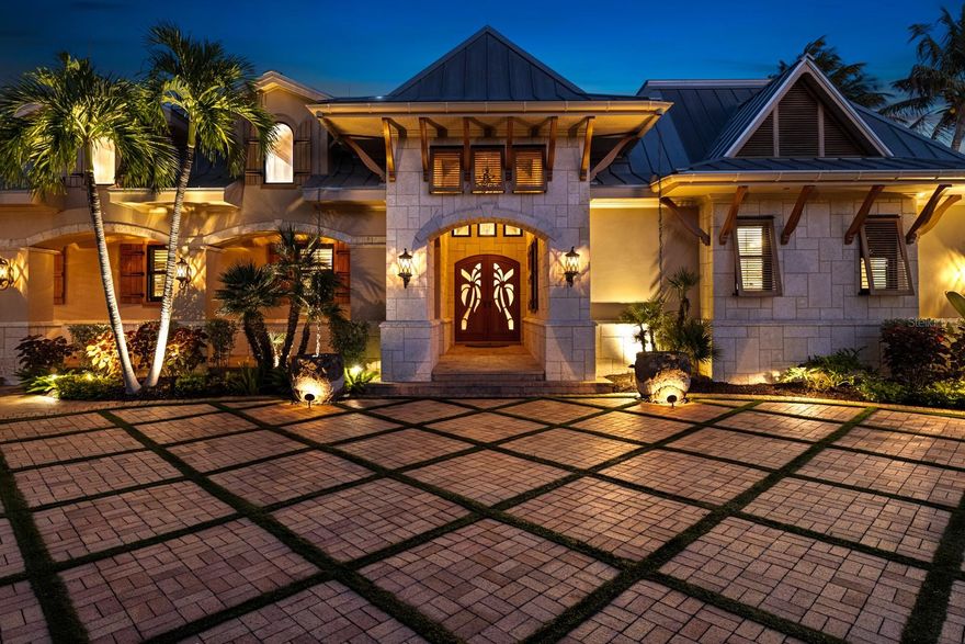 Extraordinary legacy estate in the heart of Boca Grande’s Historic District is a true West Indies–inspired sanctuary where timeless architecture, artisan craftsmanship, and tropical elegance converge. Expansive estate lot, 6,417-sq ft residence offers complete privacy and an undeniable sense of discovery—with enchanting architectural moments revealed around every corner.  
Natural stone, rich woods, and refined detailing of understated luxury. Custom mahogany and cypress accents, intricate ceiling designs, sculpted wood columns, and expansive French doors define the home’s open, flowing footprint. Impact-rated windows and doors flood each room with natural light, while it is notable that none of the living areas experienced water intrusion during past hurricanes. Dominican coral stone extends across both exterior and interior surfaces, architectural continuity reinforces the home’s island character.  Designed for effortless gatherings of any size, offers an exceptional array of indoor and outdoor entertaining spaces. Expansive living and dining areas flow seamlessly to beautifully appointed patios, covered lounges, and inviting courtyard retreats. Multiple conversation areas and a well-equipped kitchen make hosting intimate dinners and large celebrations easy. Outdoors, resort-style amenities create a private backdrop for poolside afternoons, evening cocktails, and unforgettable events—an entertainer’s dream. Over 4,000 sq ft of space that opens to a breathtaking courtyard oasis, where cascading waterfalls, lush landscaping and ambient lighting transform the grounds into a private retreat. Stunning heated pool & spa, glass-tile sunshelf complemented by an outdoor kitchen, mosquito-misting system, and whole-property landscape lighting for effortless living year-round. The chef’s kitchen boasts river granite countertops, island, custom cabinetry, premium appliances, and multiple bar areas. Modern technology integrates discreetly with the whole-home Sonos sound system and automated Lutron lighting control. Curated living and entertaining spaces include a gracious dining room, expansive living areas, a dedicated home office, and an upper-level media/entertainment room. The private owner’s wing is an intimate sanctuary with a vast bedroom offering tranquil views across the pool and gardens. The spa-inspired bath offers a luxurious retreat with an oversized walk-in shower, oversized jacuzzi tub, exotic stonework, dual vanities, and elegant lighting. Dual walk-in closets provide generous storage and customization. This 5-bedroom, 6-bath estate offers four additional guest suites, each beautifully appointed with its own ensuite bath, spacious closets, and custom finishes. For boating enthusiasts, the property’s location is second to none—moments from premier local marinas, effortless access to Gasparilla Sound and the Gulf. Enjoy a day of island hopping, world-class fishing, or a sunset cruise, and every adventure begins with ease. Privately enclosed and secured by dual power-operated gates and a paver driveway with decorative turf inlays and a fully gated perimeter for exceptional security and privacy. For pet lovers, dedicated spaces, conveniences, and secure landscaped outdoor areas provide room to roam. Perfectly equipped for pets to enjoy the luxury lifestyle right alongside their owners.
The estate is just a golf cart ride from Boca Grande’s world-renowned beaches, shopping, dining, and historic village center—yet feels worlds away.