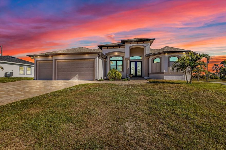This DMDean masterpiece sits on a rare DOUBLE LOT in the coveted Rotonda Sands community—offering exceptional space, privacy, and eye-catching curb appeal. From the moment you arrive, a paver driveway and grand double-door entry welcome you into a bright, open-concept design that shows like a model home. Built with both luxury and durability in mind, this home is equipped with hurricane-impact windows and doors rated to withstand winds up to 165 mph, along with additional roof reinforcement using iron rods anchored directly to the foundation—delivering unmatched structural integrity and peace of mind. It is also wired for a whole-home generator and includes a Rain Soft whole-home water system for added comfort and convenience. Inside, you'll find wood plank tile flooring throughout and a premium custom lighting package that elevates every space. The chef’s kitchen is a true centerpiece, featuring custom soft-close cabinetry, double pantries, stainless steel appliances, abundant storage, and an oversized quartz island perfect for entertaining. The thoughtfully designed split floor plan includes three bedrooms, a versatile den, and two bathrooms. The primary suite is a private retreat with sliding doors to the lanai, dual walk-in closets, and a spa-like ensuite with a walk-through shower, dual vanities, and a private water closet. Guest bedrooms are beautifully appointed and share a stylish bath that doubles as a pool bath, complete with leathered granite counters and a tiled walk-in shower. The den offers flexibility as a home office, media room, or additional guest space. Step outside to your own tropical oasis, highlighted by 17 palm trees, mature landscaping, and expansive views. The sparkling pool and oversized lanai create the perfect setting for relaxing or entertaining year-round. A spacious three-car garage provides ample room for vehicles, storage, and outdoor gear. Ideally located just minutes from Boca Grande, Englewood beaches, world-class fishing, golf, shopping, dining, and the Cape Haze Pioneer Trail, this home offers the ultimate Florida lifestyle. Impeccably maintained and loaded with high-end upgrades—this is a rare opportunity you don’t want to miss.