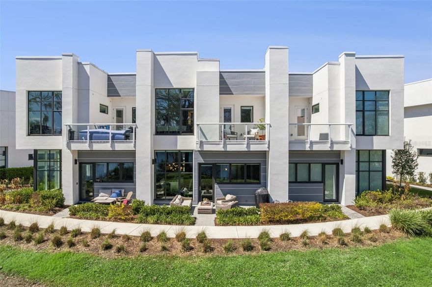 Luxury Lakeview Townhome in Winter Park! Experience elevated living in this newly built 3-bedroom, 3.5-bath residence with over 2,300 sq ft and breathtaking direct views of Lake Killarney. A dramatic 17-ft foyer welcomes you into a bright, open-concept great room featuring 11-ft ceilings and floor-to-ceiling windows that capture stunning water and nature views.  The designer kitchen is built for entertaining with quartz countertops, Wolf and Sub-Zero appliances, double-stacked soft-close cabinetry, a walk-in pantry, and custom lighting. Motorized window shades add comfort and convenience throughout. Step outside to the 22-ft oversized lanai surrounded by lush landscaping—perfect for indoor-outdoor living. Upstairs, a versatile loft/office space leads to a private balcony with cocktail kitchen and panoramic lake views. The luxurious primary suite features floor-to-ceiling windows, dual closets, and a spa-inspired bath with designer tile, dual vanities, private water closet, and oversized frameless glass shower. Two additional bedrooms each include private en-suite baths, with a conveniently located laundry room.  Additional highlights include a two-car garage with epoxy floor, EV charging plug, and extra storage. BONUS OPTION - Impossible to find boat slip on Lake Killarney available for purchase with this unique townhome.  Located in one of Central Florida’s most sought-after communities, this exceptional home combines modern luxury, scenic lake views, and an unbeatable Winter Park location. Schedule your private showing today and experience luxury lakefront living at its finest.