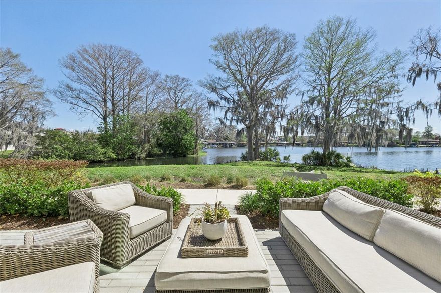 Luxury Lakeview Townhome in Winter Park! Experience elevated living in this newly built 3-bedroom, 3.5-bath residence with over 2,300 sq ft and breathtaking direct views of Lake Killarney. A dramatic 17-ft foyer welcomes you into a bright, open-concept great room featuring 11-ft ceilings and floor-to-ceiling windows that capture stunning water and nature views.  The designer kitchen is built for entertaining with quartz countertops, Wolf and Sub-Zero appliances, double-stacked soft-close cabinetry, a walk-in pantry, and custom lighting. Motorized window shades add comfort and convenience throughout. Step outside to the 22-ft oversized lanai surrounded by lush landscaping—perfect for outdoor living. Upstairs, a versatile loft/office space leads to a private balcony with cocktail kitchen and panoramic lake views. The luxurious primary suite features floor-to-ceiling windows, dual closets, and a spa-inspired bath with designer tile, dual vanities, private water closet, and oversized frameless glass shower. Two additional bedrooms each include private en-suite baths, with a conveniently located laundry room.  Additional highlights include a two-car garage with epoxy floor, EV charging plug, and extra storage. BONUS OPTION - Impossible to find boat slip on Lake Killarney available for purchase with this unique townhome.  Located in one of Central Florida’s most sought-after communities, this exceptional home combines modern luxury, scenic lake views, and an unbeatable Winter Park location. Schedule your private showing today and experience luxury lakefront living at its finest.