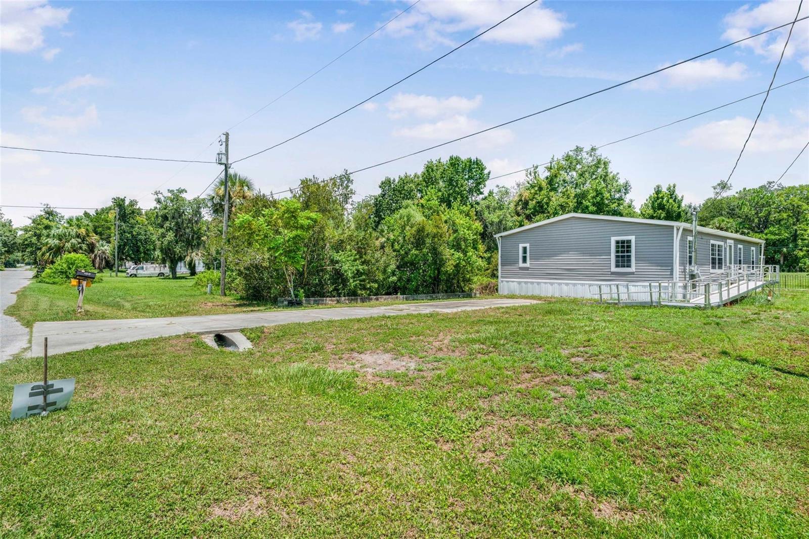 Welcome to this 2014 Live Oak mobile home in a desirable area of Homosassa. This is a 4 bedroom 2 full bath with 1,560 sf, new interior paint, new carpeting, newly installed water filtration system. The best part of this home is it sits on lot 8 and the second lot which is lot 9 has your very own pond where you can watch the wild life from the back deck or from your dining room window. It has a retention wall with an assortment of plants, some native and some planted by the previous owners. The primary bedroom has large walk in closet and there is plenty of storage in the kitchen and the extra cabinets in the laundry room. The septic has been pumped and inspected, the home has been pressure washed, concrete parking pad. Whether you are seasonal or full time residents you will enjoy all the Homosassa area has. Spectacular fishing, crabbing and scallop hunting. The Homosassa Springs Wildlife Area is just a few miles down the road along with shopping and restaurants and a hop skip and jump to Crystal River and Three Sisters Springs and the shopping and restaurants there. Don't miss out on this opportunity for a spot in Paradise.