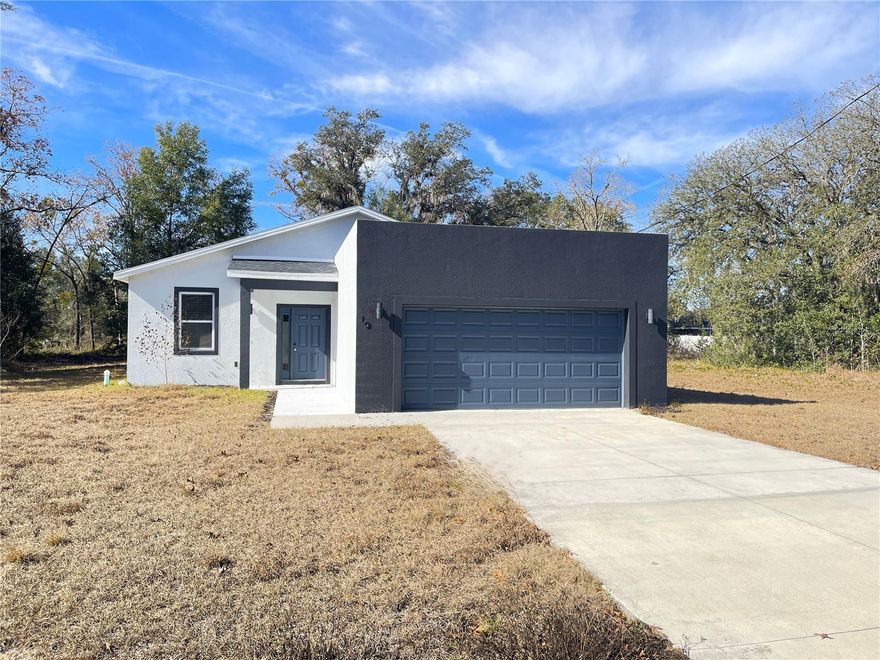 Available now and unlike anything else on the market. This almost new (2023 built) 3 bed 2 bath retreat is made for you. From the moment you step inside, the space feels intentional, modern, and effortless. The open living area flows naturally into a stunning kitchen with sleek solid surface counters, perfect for hosting or unwinding after a long day. Slide out to the covered porch and imagine quiet mornings with coffee or relaxed evenings as the sun goes down. Every detail works together, including a thoughtfully designed mudroom and laundry space that keeps life organized. What truly sets this home apart is how smart it is. This is not just a house with gadgets, it is a home that works for you. Charge your electric vehicle at home, breathe cleaner air with built in UV purification, control lighting, climate, and garage access with ease, and monitor energy usage through a smart electrical panel that puts efficiency and control at your fingertips. It is comfort, convenience, and future ready living wrapped into one beautiful space. Located in the peaceful beauty of Ocklawaha, you get the best of both worlds. Quiet surroundings when you want to disconnect and easy access to golf, shopping, and everyday essentials when you want to get out and enjoy life. Spend the morning on the course, the afternoon shopping at Lady Lake Commons, and come home to a space that feels calm, modern, and completely yours. This is not just a place to live. It is a lifestyle upgrade. Call today and schedule your showing!