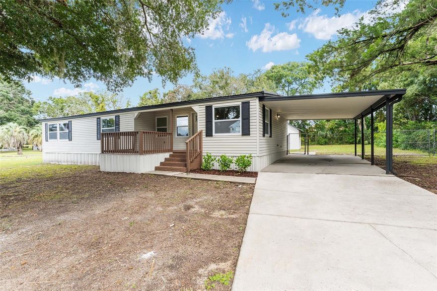Completely Renovated and Move-In Ready! This beautifully updated doublewide mobile home offers over 1,300 sq ft of comfortable living space with high-end finishes and thoughtful details throughout. Recent upgrades include a newer metal roof and HVAC system, a welcoming front porch deck, and a spacious covered back patio perfect for relaxing or entertaining. Enjoy peace and privacy in the fenced backyard, which features a 395 sq ft built-in storage unit—fully powered with electric and water, offering endless possibilities for a workshop, studio, or hobby space. With a government owned easement behind the property, you’ll appreciate having no immediate rear neighbors.
Inside, this home impresses with recessed lighting, luxury vinyl plank flooring throughout, and a bright open-concept floorplan. The island kitchen is a showstopper, featuring quartz countertops, stainless steel appliances, and ample cabinet and counter space for the home chef. The primary suite offers a true retreat with a massive walk-in shower, dual vanities, and an oversized closet for plenty of storage.
Additional highlights include an extra-large carport and a prime location conveniently situated between Ocala and The Villages, close to shopping, dining, and medical facilities.
This one checks all the boxes—modern style, functionality, and comfort—all in a fantastic central location!