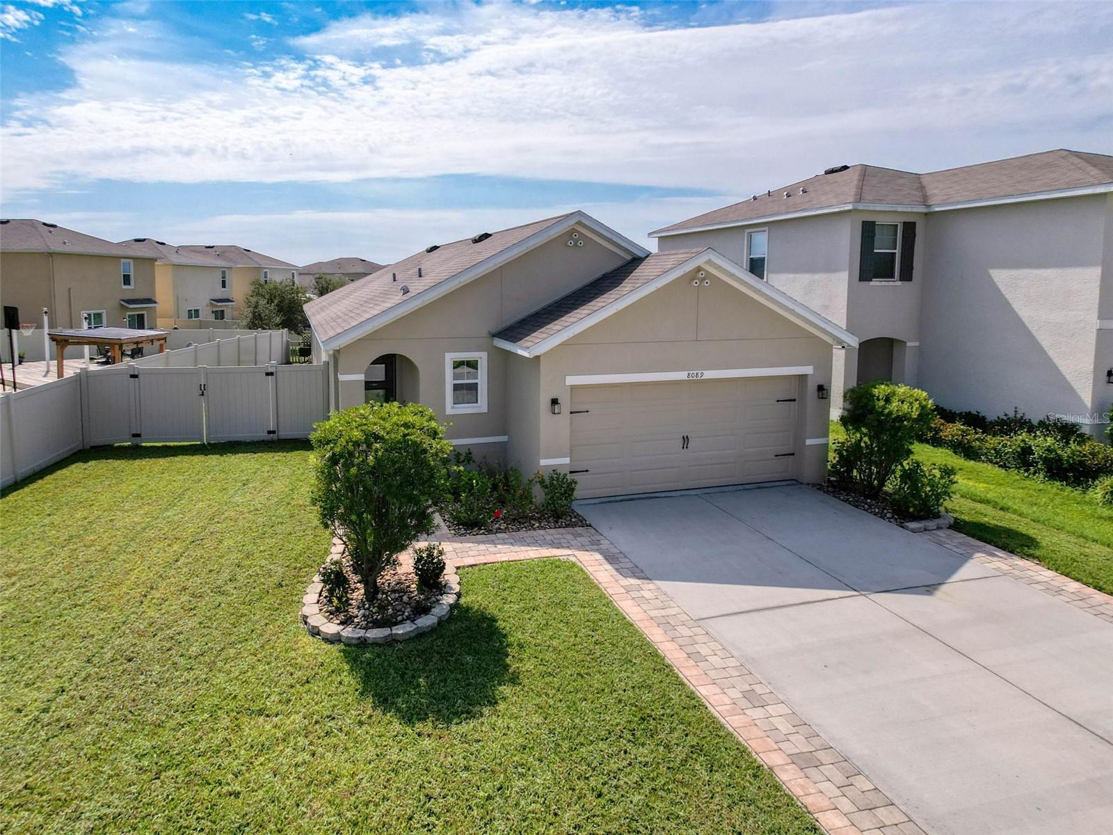 HOME SWEET HOME! WOW! This perfect MOVE IN READY 3 bedroom 2 bath 2 car garage home, is FULLY FENCED, showcasing a beautiful backyard WATER view, and located in popular Wesley Chapel FL in the desirable EPPERSON RANCH! This community is the epitome of the Florida lifestyle with the very first CRYSTAL LAGOON, pure blue waters, white sandy beaches and lounge chairs for all day relaxation. The lagoon community lifestyle features a swim up bar, restaurant, Events calendar, kayaking, paddleboarding, GIANT slides and GOLF CARTS welcomed! This home is almost new DR HORTON build ALLEX model also features a split bedroom plan, gorgeous gourmet kitchen with GRANITE countertops, STAINLESS STEEL appliances, unique oversized kitchen farm-style sink and espresso cabinetry. The floorplan is perfect for entertaining and cozy for just quiet times! Meticulously maintained, you'll also enjoy the screened in lanai overlooking the pretty water view of the pond and offers an extra wide side yard with gate. The primary bedroom is also spacious, overlooks the water, has a WALK IN CLOSET and an en-suite bath with granite countertops and dual vanities. This home is just waiting for you! Additionally, the EPPERSON RANCH community clubhouse and Lagoon area offers Live Music, a swim up bar, dog park, golf cart paths and this home is less than 5 minutes to the Publix shopping center and local stores, car wash, schools are nearby with hospitals and medical services within 10 minutes. Downtown Tampa, USF, VA and the Tampa airport are approximately 45 minutes away, 15 minutes to The Shoppes Of Wiregrass, a local outdoor mall and Orlando theme parks are less than 90 minutes away. The location is perfection! Everything is so convenient you will not be disappointed!