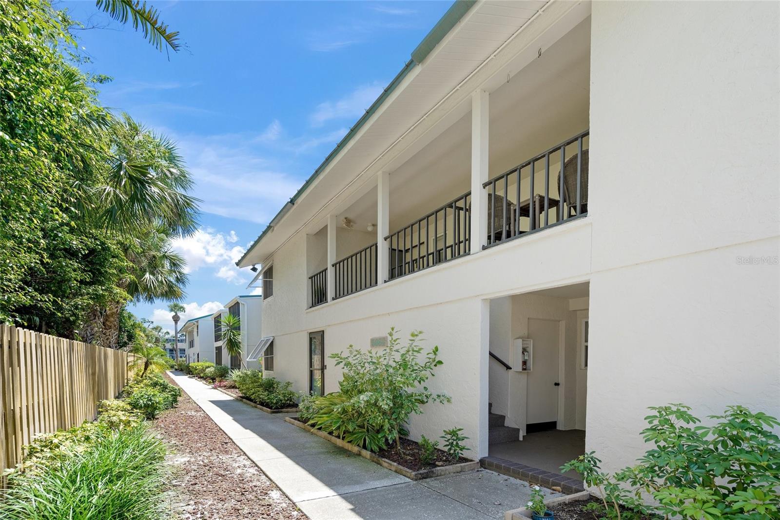 Welcome to your relaxation destination- White Sands Village- located across from Tripadvisor's #1 RATED BEACH IN THE U.S. AND #4 IN THE WORLD- SIESTA BEACH! Let the cool quartz white powder sand and clear water soothe your soul. This comfortable 1,012 sqft, TURN KEY FURNISHED, 2 bedroom/ 2 bath condo has recently been refreshed by a professional designer. The UPDATED, opened up kitchen features granite countertops, stainless steel appliances and a delightful window looking out to the lush tropical greenery. Entertain guests in the open plan dining and living room. The 2 spacious bedrooms offer multiple large closets and plenty of room to accommodate additional visitors. You'll love that the 2 bathrooms are updated with granite countertops and there is hard flooring throughout the condo. Enjoy sunsets and a peek-a-boo boat basin view while sipping your favorite cold beverage from the screened lanai. This 2nd floor unit is ideally positioned in the back of the complex in an end building providing privacy and tranquility with no one above you...and peace of mind with it being high and dry! The community features a charming clubhouse with sauna, heated pool, BBQ grills, picnic areas, boat docks available for rent annually on a first come first serve basis, multiple laundry facilities and designated parking spaces under shaded carports as well as plenty of open guest parking. Just across the street at the public beach you'll find tennis, pickleball, volleyball and a playground! Take the trolley to Siesta Village for delicious local restaurants, live music, farmers market, festivals, fitness and shopping. The flexible 2 week and pet friendly rental policy combined with the ON-SITE rental management office makes this an excellent investment opportunity that's easy breezy! Call today to schedule your private showing and start living the Florida dream!