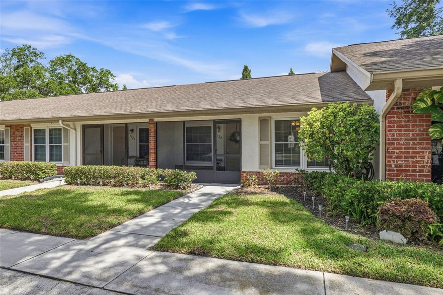 Welcome to the highly sought after Scotsdale community, one of Dunedin’s most well-established 55+ communities known for its peaceful tree-lined streets, welcoming atmosphere, and unbeatable location close to everything locals love about the area. Tucked away on a private cul-de-sac with an assigned covered parking space just steps from your door, this charming 1-bedroom, 1-bathroom villa offers the perfect blend of comfort, convenience, and low maintenance Florida living. As you arrive, a screened and tiled front porch welcomes you inside, creating the perfect spot to enjoy your morning coffee or unwind in the evenings. Step inside to a spacious living and dining room combination featuring luxury vinyl wood flooring throughout, crown molding, and a bright, inviting layout that feels instantly like home. Just off the dining area, the kitchen offers stainless steel appliances, plenty of cabinet storage, and a convenient passthrough window overlooking the additional living space. The owner’s suite is generously sized and ideally located next to the updated bathroom for added functionality and comfort. One of the standout features of this home is the converted screened porch, offering a versatile bonus space complete with built-in cabinetry and additional storage closet, perfect for a sitting room, office, or reading nook. Additional upgrades include in-unit laundry and a 2019 AC unit for added peace of mind. This property also sits high and dry with no flood insurance required. Residents of Scotsdale enjoy a low maintenance lifestyle with HOA fees that include cable TV, internet, water, sewer, trash, exterior maintenance, grounds maintenance, and access to resort-style amenities including a heated community pool, pickleball and tennis courts, shuffleboard, and clubhouse. Residents also have access to a second nearby pool along with Scotsdale Park featuring walking trails, a scenic lake, playground, and picnic pavilion. The location truly makes this home special, perfectly positioned in the heart of one of Tampa Bay’s most beloved coastal towns. Dunedin is known for its vibrant yet laid-back atmosphere, blending charming small-town character with endless things to do. Just minutes away, historic downtown Dunedin is filled with locally owned boutiques, waterfront restaurants, craft breweries, coffee shops, and year-round festivals that give the town its unique energy and sense of community. Outdoor lovers will appreciate easy access to the Pinellas Trail, nearby golf courses, waterfront parks, and the Dunedin Causeway leading directly to the award-winning beaches of Honeymoon Island State Park and Caladesi Island State Park. Baseball fans will also love being close to the Toronto Blue Jays spring training stadium. Whether you are looking for a seasonal retreat or full-time residence, this is your opportunity to enjoy the very best of the Florida lifestyle in one of the Gulf Coast’s most desirable communities. Schedule your showing today!