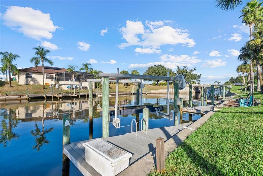 WATERFRONT WITH PRIVATE DOCK & BOAT LIFT! X FLOOD ZONE. COMMUNITY POOL. 2 BEDROOMS, 2 BATHS. LARGE LANAI OVERLOOKING SCENIC CANAL. Welcome to your slice of Florida paradise! This beautifully maintained end-unit villa sits on a saltwater canal with a private dock and boat lift, offering direct access to endless days on the water. Enjoy peace of mind knowing there was no flooding during recent hurricanes—and a new roof in 2022. Step inside to find an open and airy floor plan filled with natural light. The spacious living and dining area features cathedral ceilings and a wood-burning fireplace, creating a cozy yet coastal atmosphere. The kitchen boasts quartz countertops, newer appliances, and plenty of cabinetry for storage. Adjacent to the kitchen, the indoor laundry room offers a built-in desk and additional pantry cabinets. The living room overlooks the water and opens fully to the screened-in lanai through pocketing sliding glass doors, creating seamless indoor-outdoor living. The primary suite features lanai access, two windows with water views, and a completely remodeled ensuite bathroom designed for luxury and efficiency. The guest bedroom includes a large walk-in closet and a renovated guest bathroom. One of the home’s most unique features is its private atrium, the perfect spot to create your own garden retreat. Step outside to the shared pavered patio directly on the water, where you’ll enjoy front-row views of fish, dolphins, and manatees. Windsor Villas is an intimate community of just six homes that welcomes up to two household pets. The community pool is only steps from your front door, and your one-car garage includes a retractable screen. Other highlights include plantation shutters and Hunter Douglas blinds.  Located less than 4 miles from Manasota Key Beach, minutes from Dearborn Street’s boutique shops and dining and close to Venice shopping, dining, and beaches.  This home offers the best of waterfront living with the charm of Englewood nearby. Copy and Paste the following link for a luxury video: https://player.vimeo.com/video/1132506067?badge=0&amp;autopause=0&amp;player_id=0&amp;app_id=58479