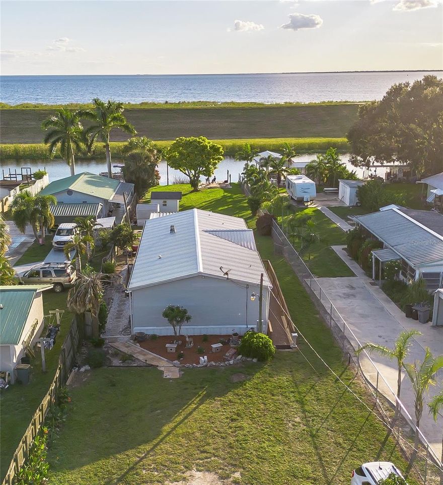 RIM CANAL - Lake Okeechobee Access!
Well Maintained Waterfront Beauty. DWMH 3 BD / 2 BA 1,512 Sf under air - 1818 TLA
Enjoy the eat-in kitchen, formal dining room, Spacious living room with Fireplace, and Laundry room. Updated flooring in the living room, kitchen and dining area. Plenty of room! (1) 8x8 and (1) 10x15 utility shed detached. 
Front Ramp. Enjoy BEAUTIFUL SUNSETS from the back yard . 
Great for year-round Living or a Winter Getaway. And perfect for the avid fisherman! Dimensions are approximate, must measure for exact.