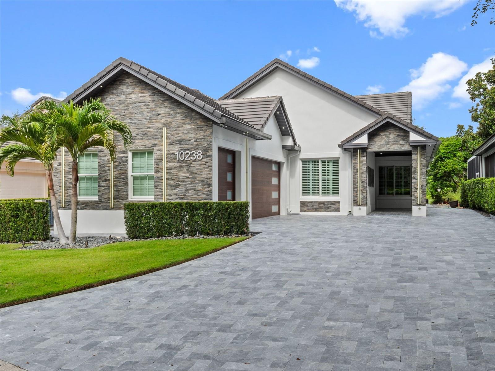 Seller may consider buyer concessions if made in an offer // Welcome to the one you’ve been waiting for! A show-stopping modern home in the heart of Lake Nona Estates, perfectly positioned on a premium practice RANGE LOT with sweeping golf course views and all the HIGH-END UPGRADES you didn’t know you needed! Located on a quiet street in one of Orlando’s most sought-after GUARD GATED communities, this home has serious CURB APPEAL, a freshly manicured exterior, and the kind of elevated style that turns heads. Step inside and feel the difference – soaring ceilings, sleek crown molding, wood beam accents and a light-filled OPEN CONCEPT that feels both spacious and effortlessly chic. The living area is centered around a CUSTOM FIREPLACE feature wall and framed by HIGH-END WINDOWS and sliders that bring the outdoors in. The kitchen? An absolute chef’s kiss! You will be surrounded by solid wood cabinetry, stone countertops, a SUB-ZERO FRIDGE, WOLF GAS RANGE, built-in wine/beverage fridge, and top of the lines appliances ready for your next dinner party or quiet meal at home. You will want to spend every evening on the OVERSIZED SCREENED LANAI, complete with remote control screens and an EXTENDED PATIO with a BUILT-IN GAS FIREPIT – all perfectly positioned for those gorgeous golf course views. Your primary suite is a vibe all its own: spacious and stylish, it delivers a well appointed en-suite bath, CUSTOM WALK-IN CLOSET, and a private FLEX SPACE that opens to the backyard. Use it as a home gym, nursery, studio or office – the natural light and privacy will inspire whatever you make of it. The SPLIT BEDROOM floor plan is ideal and both guest rooms come with their own en-suite bath access, making everyday living or overnight guests feel like they are in a luxurious escape. There is also a convenient half bath and a custom laundry room that actually makes doing laundry feel less like a chore. There are tons of updates throughout the home including; a NEW TILE ROOF (2018), UPDATED A/C, TANKLESS WATER HEATER, and energy-efficient double pane, low-E windows. Every inch is thoughtfully designed with WOOD and TILE FLOORS throughout, ceiling fans in all the right places, and a 3-CAR GARAGE with space for your GOLF CART. You are just minutes from Lake Nona Golf & Country Club and residents will enjoy water access, boat ramps, fishing and RESORT-STYLE AMENITIES as part of everyday life. All of this comes with TOP-RATED SCHOOLS, unbeatable shopping, dining and entertainment options, quick access to major roadways like SR 417 and 528, and the Orlando International Airport. This is not just a home – it’s a statement! Bold, modern, upgraded and move-in ready. This is Lake Nona living at its absolute best, call today to schedule your private tour!