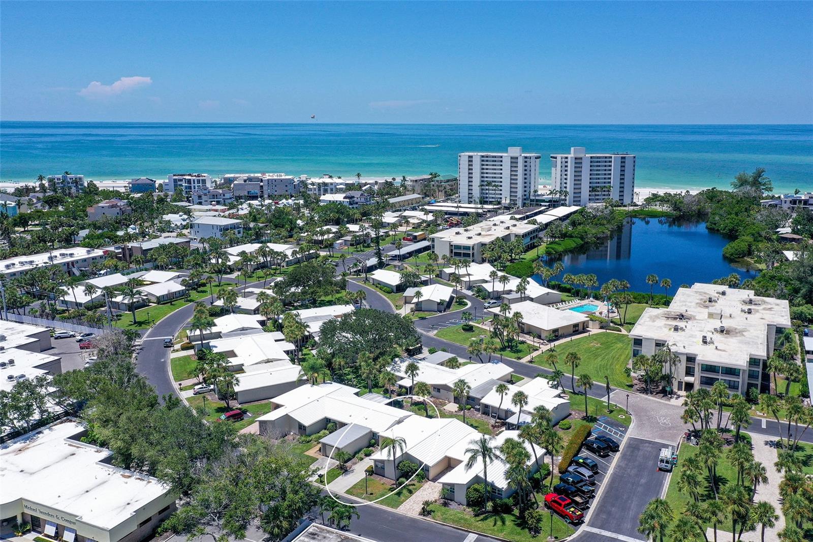 Enjoy effortless coastal living in this beautifully REMODELED, 2 bed/2 bath GULFSIDE villa with GARAGE, offered TURNKEY FURNISHED - with BRAND NEW 2025 furniture and furnishings! From the moment you arrive, you'll appreciate the thoughtful updates and fresh cohesive coastal decor that make this residence a stunner - and completely move-in ready. The all NEW galley kitchen boasts white custom cabinetry, granite countertops & backsplash, recessed lighting, and brand new GE appliances - perfect for preparing easy meals after a day at the beach. The well appointed, open concept living and dining areas flow seamlessly to the open air patio through two sets of French doors, creating an inviting indoor/outdoor feel. NEW porcelain tile floors throughout the main living areas add a touch of sophistication, while the bedrooms offer comfort with NEW plush carpeting. Both bathrooms have been stylishly remodeled with new cabinets, granite counters, and modern fixtures. The ensuite primary bathroom provides a bit of luxury with dual sinks, granite counters, a separate vanity, a spacious walk-in closet, and a linen storage closet. A NEW full-sized washer & dryer adds convenience, and the attached ONE CAR GARAGE also offers extra storage for your bikes or beach essentials. NEW 2025 VILLA ROOF. Located just around the corner from the beautiful clubhouse pool and only a short stroll to 800’ of your own PRIVATE quartz sand beach on the GULF and a second, beachside pool. And with Siesta Key Village’s vibrant shops and restaurants right next door, this villa is also perfectly positioned for enjoying the best of Siesta Key. Whispering Sands is a premier 55+ GULF FRONT complex offering its own private beach, 2 pools, clubhouse (currently being remodeled), canoe/kayak storage, shuffleboard, onsite management & maintenance staff, and security. Whether you're seeking a serene full-time residence or a seasonal retreat, this exceptional, well priced villa offers the ultimate in island living!