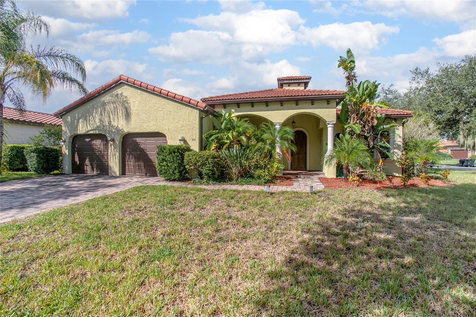 Welcome to Riviera Bella, one of DeBary’s most desirable gated communities, where this elegant Spanish Mediterranean-style pool home awaits. Situated on a corner lot, this 4-bedroom, 2-bath, single-story residence offers timeless design, modern convenience, and plenty of space to live, work, and entertain. From the moment you arrive, the curb appeal is evident with its striking tile roof, covered front porch, and oversized garage. Inside, natural light pours into the open, split-bedroom floor plan, showcasing refined architectural details such as tray ceilings, arched entryways, crown molding, and decorative columns. Generously sized living and dining areas offer flexibility—whether you prefer a formal setting or envision a lounge, game room, or reading retreat. The owner’s suite is a true retreat, featuring private access to the pool, tray ceilings, a spa-like bathroom with soaking tub, walk-in shower, dual vanities, and spacious closets. Step outside to your very own backyard paradise: a screened-in pool and spa surrounded by tropical landscaping, a paver deck, and a fully equipped outdoor kitchen—all designed for relaxation and entertaining. The heart of the home is the kitchen-family room combination, where you’ll find solid wood cabinetry, granite countertops, bay windows, and a gas fireplace that creates a warm and inviting atmosphere. With natural gas throughout the home, efficiency and convenience are built right in. Riviera Bella offers a resort-style lifestyle with a clubhouse, fitness center, community pool, splash pad, and peaceful ponds throughout the neighborhood. Boating enthusiasts will appreciate the private community boat ramp with direct access to the St. Johns River. Perfectly located near shopping, dining, SunRail, and major highways, this home combines tranquility with accessibility. Experience luxury living in DeBary—schedule your private tour of 100 Via Rosa Ct today and make this exceptional property yours!