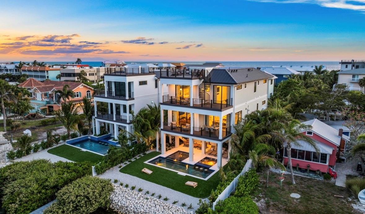 Introducing Your Dream Waterfront Oasis in Bradenton Beach. Nestled in the heart of Bradenton Beach, this exceptional waterfront home offers the ultimate coastal living experience. Brand new constuction and thoughtfully designed, this direct bayfront residence is a true gem. With 7 bedrooms and 7.5 bathrooms across its spacious 3,245 sq ft, you'll have ample room for your family and guests. Arriving home is a breeze with a 3-car garage and the added convenience of an ELEVATOR. The open-concept design features a captivating great room floor plan, seamlessly connecting all the living spaces. Step into the large dining area, where sliders lead to a covered patio, creating the perfect setting for al fresco gatherings and breathtaking views of the surroundings. For those who love to cook, the chef's kitchen with a center island is a culinary haven that offers both functionality and style. As you ascend to the rooftop deck, you'll be mesmerized by panoramic bay views, providing an idyllic spot to savor breathtaking sunsets and create cherished memories. Embrace the outdoors with a covered patio and an inviting pool area, complete with a heated pool and spa for year-round enjoyment. This prime location puts you within walking distance to the beach and Bridge Street, known for its array of charming shops and restaurants. Here, you'll experience the perfect blend of relaxation and entertainment at your fingertips. This bayfront beauty presents an incredible opportunity to own a slice of paradise where comfort, luxury, and coastal charm harmoniously unite. THIS PROPERTY WOULD AN EXCELLENT INVESTMENT PROPERTY. WE HAVE PROJECTED RENTAL INCOME AVAILABLE. Don't miss the chance to make this remarkable home your very own! Contact us today to learn more and schedule a private showing.