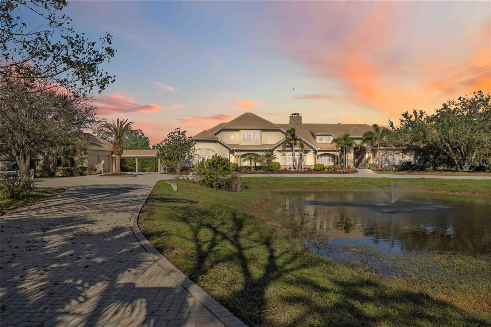 One or more photo(s) has been virtually staged. Welcome to this breathtaking custom estate home, perfectly situated on a generous 9.72-acre lot in the prestigious gated community of Saddle Oak Estates. This remarkable home features 4 bedrooms, 4.5 baths, 4-car garage, along with concrete stable with 4 horse stalls plus tack room, making it an ideal haven for equestrian enthusiasts and car collectors alike. The property features fencing and cross fencing, along with property suited for future arena area. Located just 5 miles east of I-75 in Sarasota, FL, this residence offers a serene retreat while still providing easy access to all the Sarasota attractions you desire. Designed with energy efficiency at its core, this expansive estate boasts insulated concrete form exterior walls, open-cell spray foam insulation, under-roof sheeting, and dual-pane insulated windows throughout. Inside, you'll find metal stud walls, solid core doors, elegant crown molding, built-in shelving, and abundant storage, all reflecting exceptional craftsmanship and attention to detail. The gourmet kitchen has been completely remodeled and features new cabinetry, a spacious walk-in pantry, a gas cooktop, a wall oven, a built-in microwave, stunning quartz countertops and backsplash, beverage fridge, and fresh paint throughout. The living room features stunning reclaimed wood, new light fixture, and a cozy fireplace. Dual washer and dryers in the laundry room! The large screened outdoor lanai is perfect for entertaining, complete with a heated pool and spa for year-round enjoyment. A tankless gas water heater adds to the home's energy efficiency. There’s also a generator for backup power when needed.
The property includes an oversized attached two-car garage, as well as a detached two-car garage with 10-foot doors and high ceilings, ideal for a workshop or additional storage. With luxurious designer finishes throughout, this home is built to impress on every level. Saddle Oak Estates is conveniently located just 5 miles from I-75 and a short 25-minute drive to the stunning Siesta Key, offering the best of Sarasota living while ensuring your privacy. Don’t miss the opportunity to experience the tranquility and elegance of this extraordinary property—schedule your showing today! Be sure to check out the #D virtual tour and the property video: https://youtu.be/2zjjdp53qlU